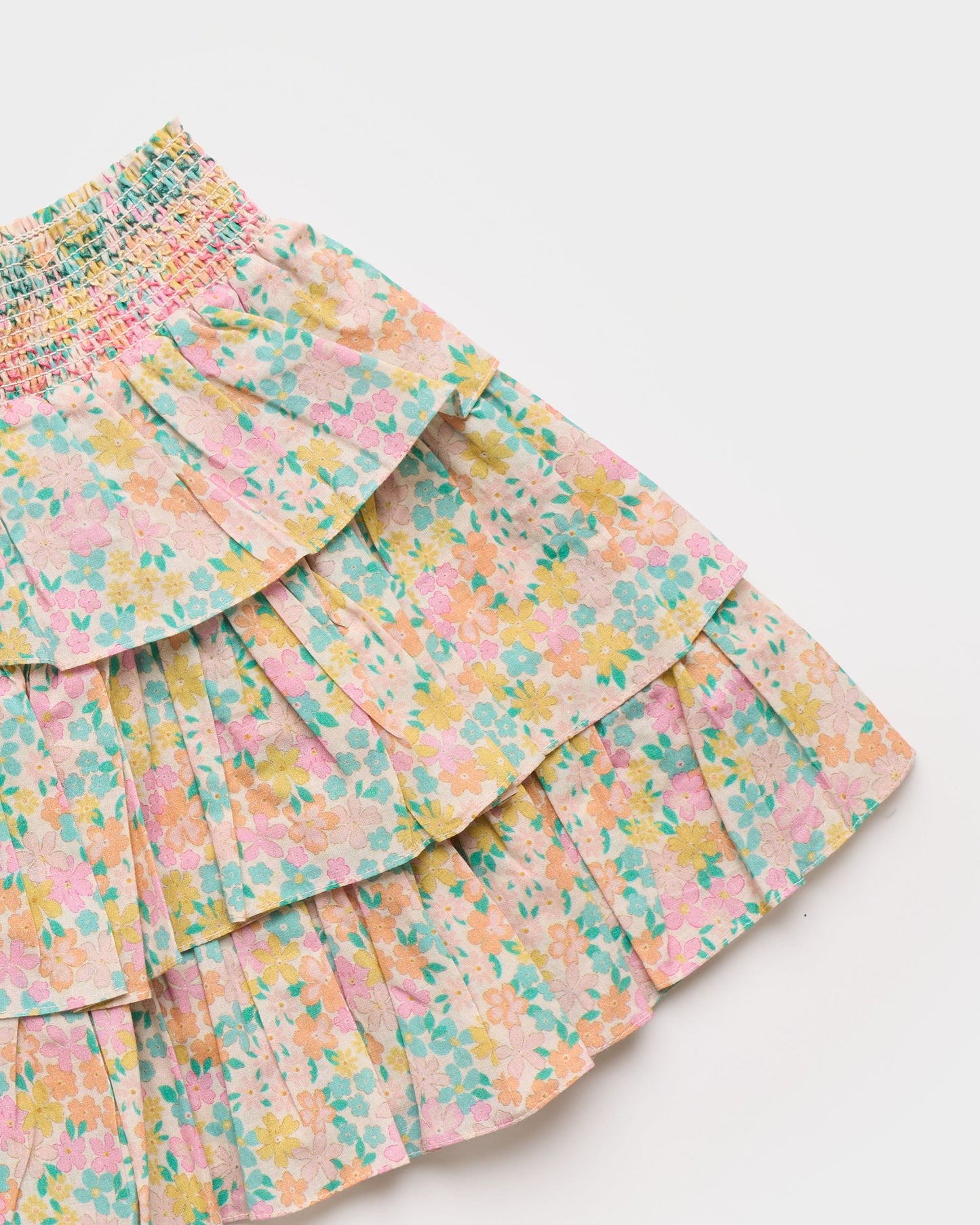 Early Sunday, Melissa Skirt in Emma Floral Mint color, made from Organic Printed Cotton Cambric fabric, featuring tiered frilly skirt with smocked waistband, shown in a closeup flat-lay view