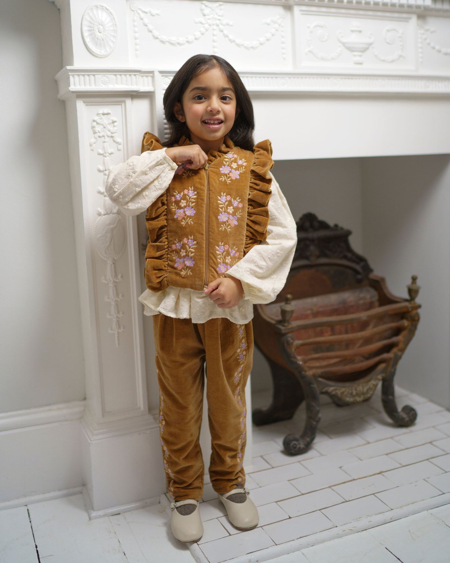 Early Sunday, Adrien Trouser in Almond, made from Dyed Cotton Velvet fabric, featuring Relaxed design with ample room for movement, perfect for active kids, shown in a front view of a model wearing it in a studio setting