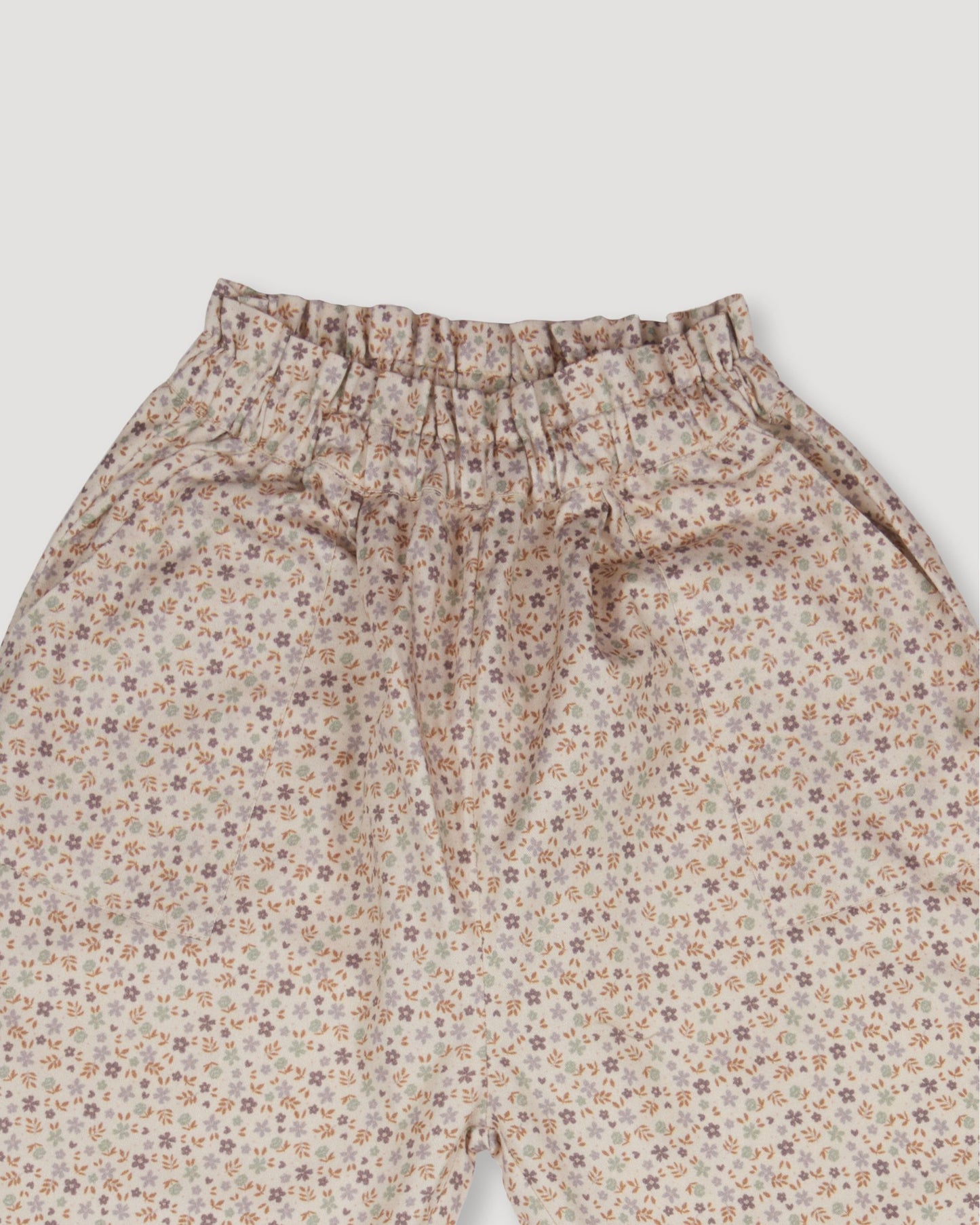 Early Sunday, Adrien Trouser in Miny Flowers print, made from Printed 30s Cotton Twill fabric, featuring Relaxed design with ample room for movement, perfect for active kids, shown in a closeup flat-lay view