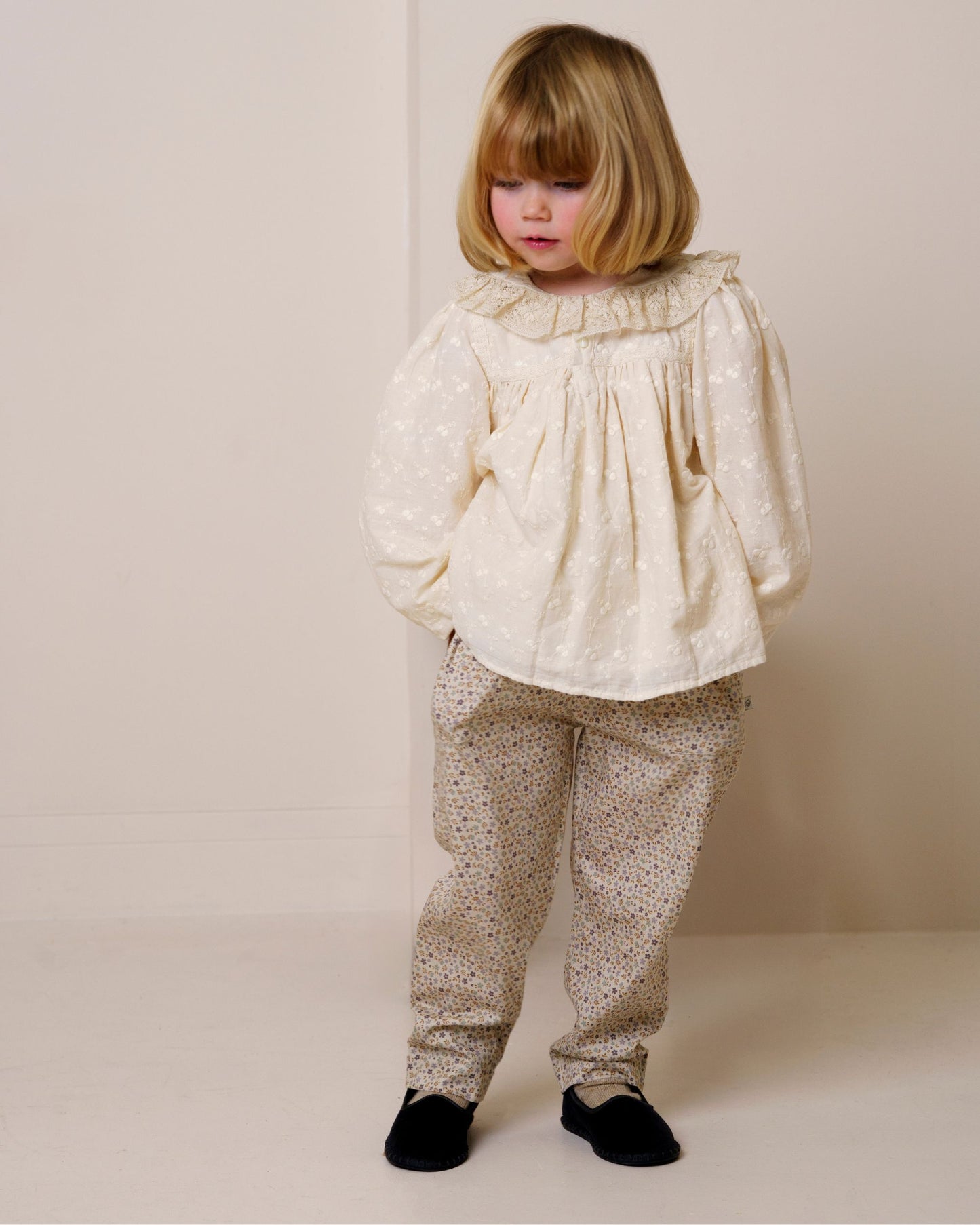 Early Sunday, Adrien Trouser in Miny Flowers print, made from Printed 30s Cotton Twill fabric, featuring Relaxed design with ample room for movement, perfect for active kids, shown in a front view of model wearing it