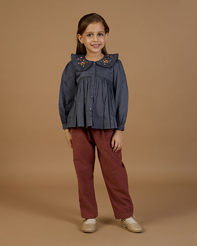 Early Sunday, Adrin Trouser in Caramel, made from Cotton Corduroy fabric, featuring a relaxed silhouette with a comfortable elastic waistband, shown in an angled view of a model wearing it in a studio setting
