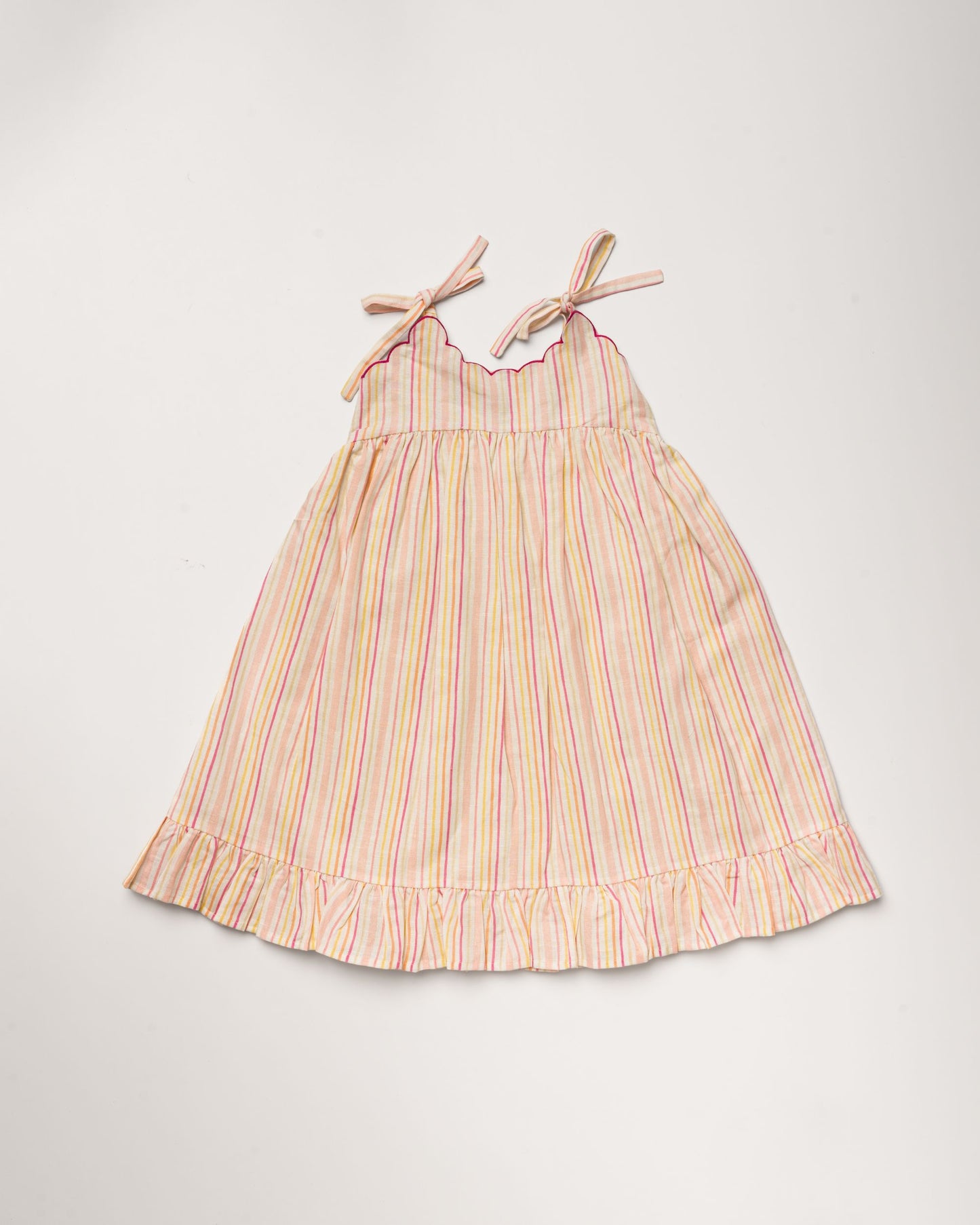 Early Sunday, Alena dress in Pink Stripes color, made from printed 70% cotton 30% linen fabric, featuring tie-up shoulder straps, gathered flare, and ruffled hem, shown in a front flat-lay view.