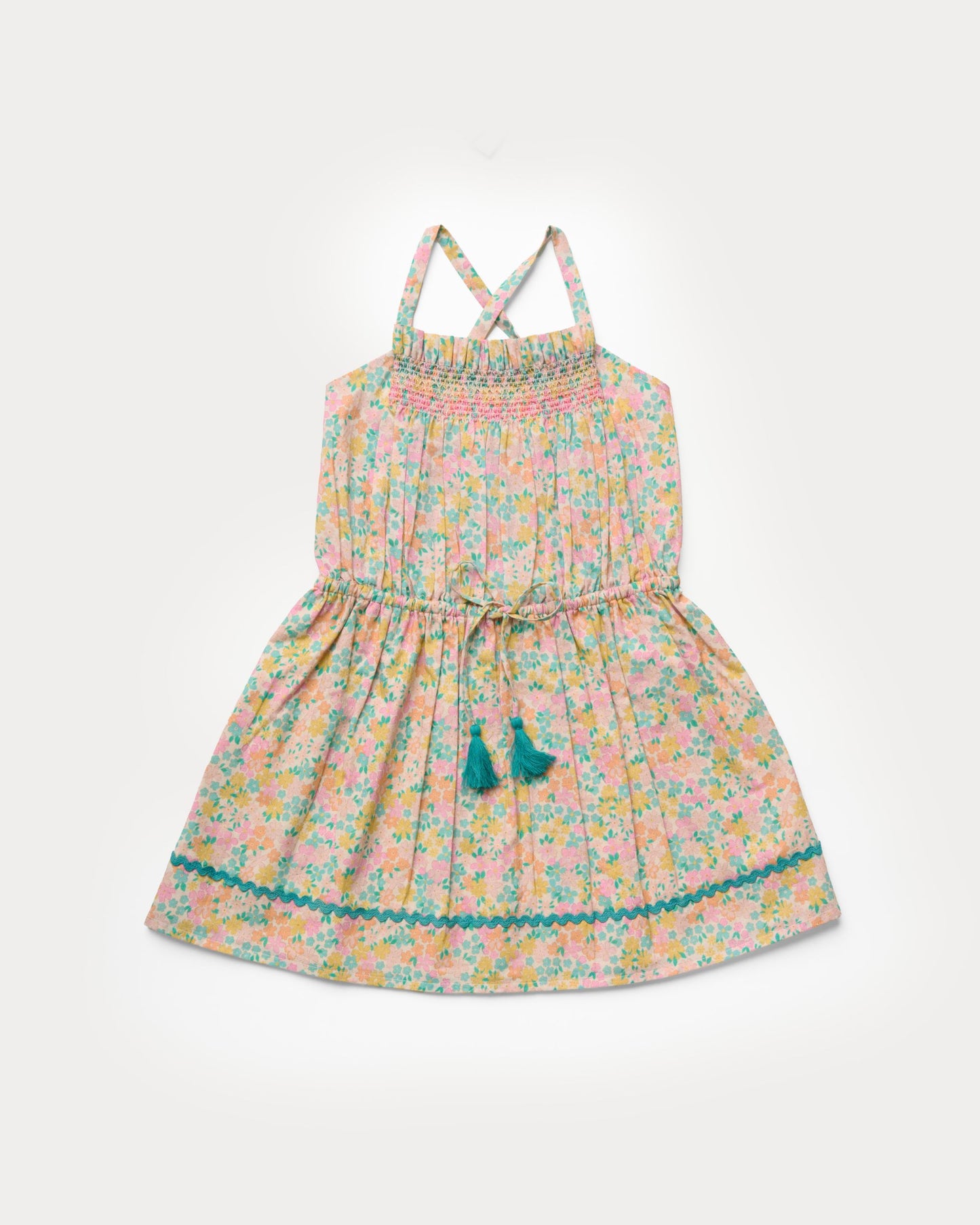Early Sunday, Alisson Dress in Emma Floral Mint color, made from organic printed cotton cambric fabric, featuring smocked bodice, adjustable shoulder straps, sweet tassel accents, and a flowy gathered skirt, shown in a front flat-lay view.