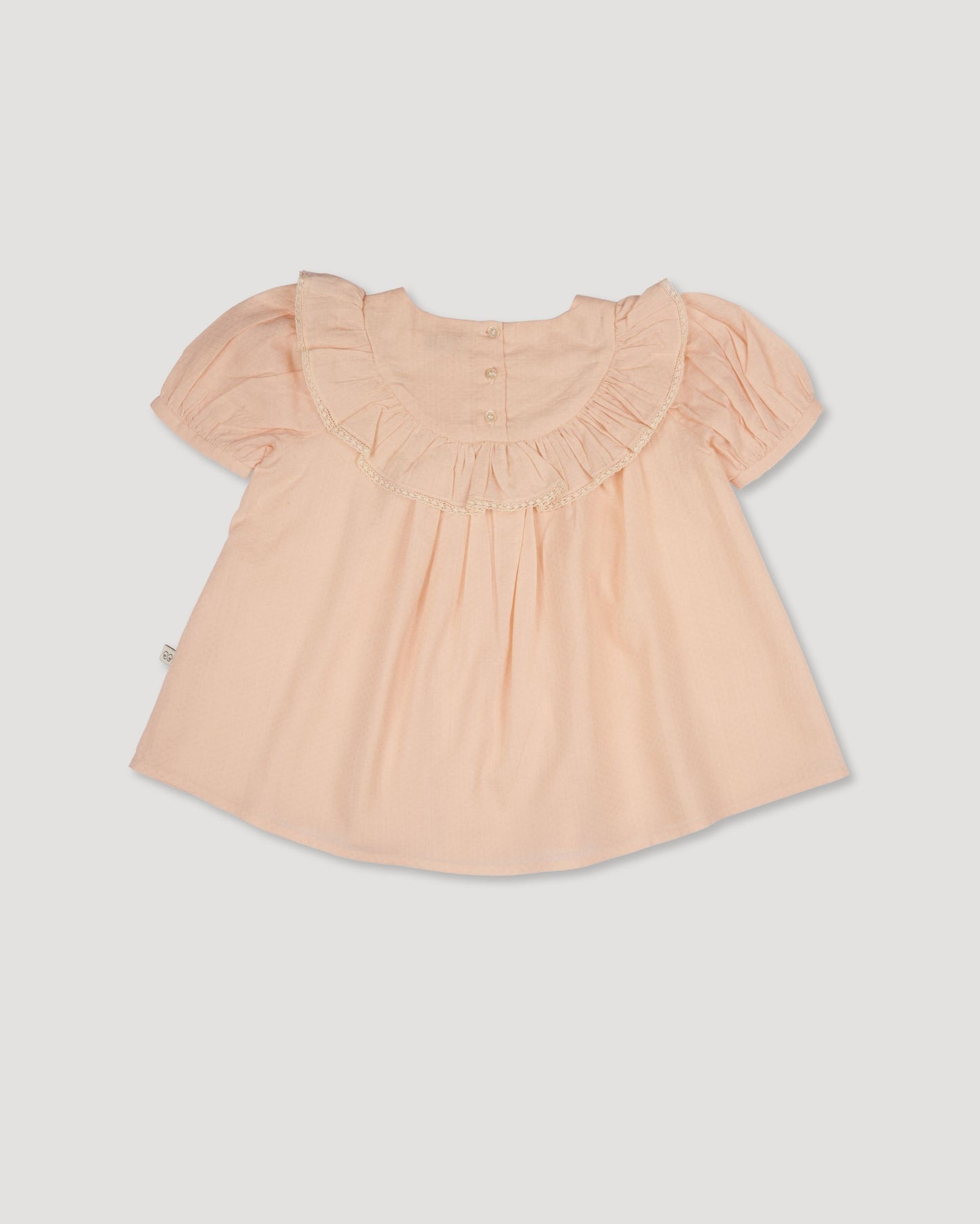Early Sunday, Amelia Blouse in Nude, made from Dyed Cotton Swiss Dobby Tiny Dots fabric, featuring Classic pleats that enhance the fit and finish, shown in a back flat-lay view