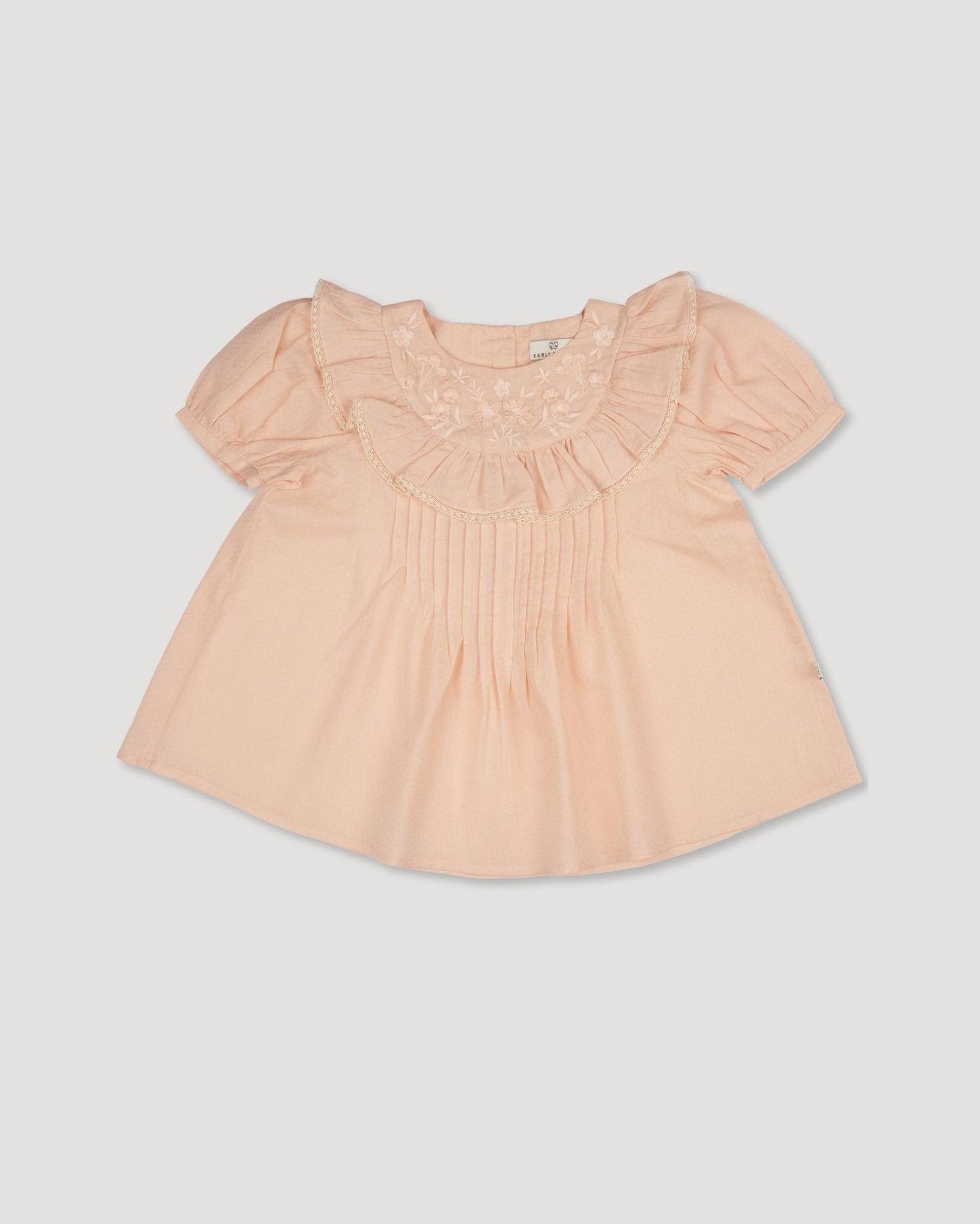 Early Sunday, Amelia Blouse in Nude, made from Dyed Cotton Swiss Dobby Tiny Dots fabric, featuring Classic pleats that enhance the fit and finish, shown in a front flat-lay view
