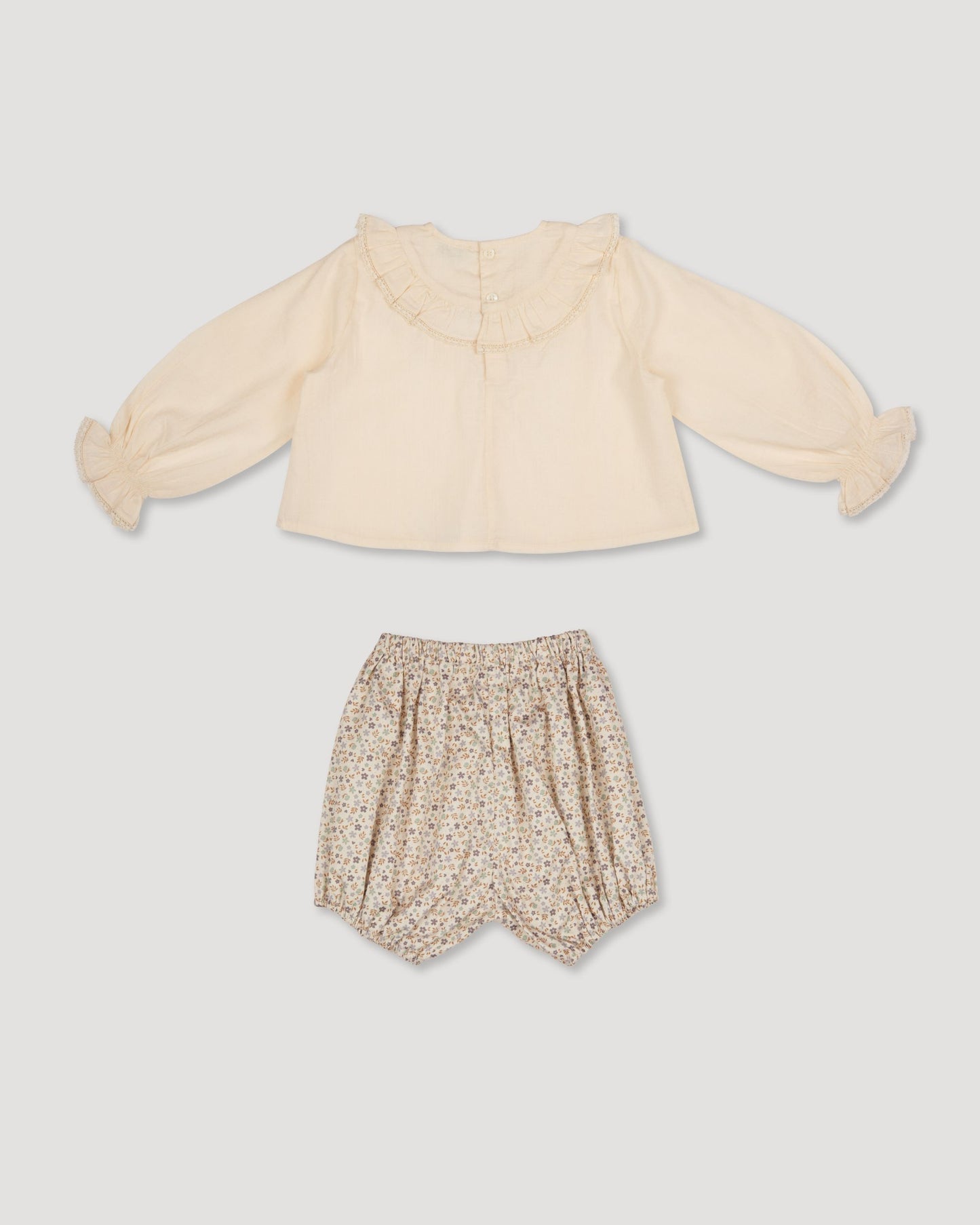 Early Sunday, Amy Baby Blouse & Bloomer Set in Hazelnut Cream & Mini Floral print, made from Dyed Cotton Swiss Dobby Tiny Dots fabric, featuring a full sleeves with beautiful embroidery & printed floral bloomers, shown in a back flat-lay view