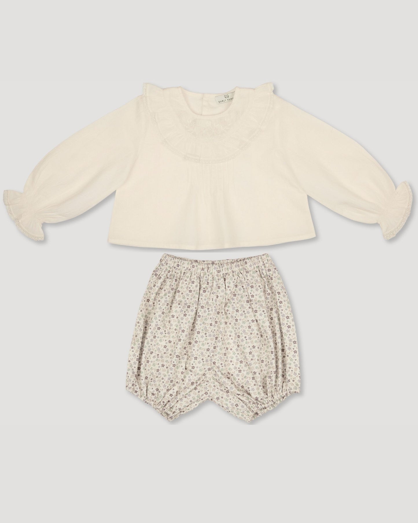 Early Sunday, Amy Baby Blouse & Bloomer Set in Hazelnut Cream & Mini Floral print, made from Dyed Cotton Swiss Dobby Tiny Dots fabric, featuring a full sleeves with beautiful embroidery & printed floral bloomers, shown in a front flat-lay view
