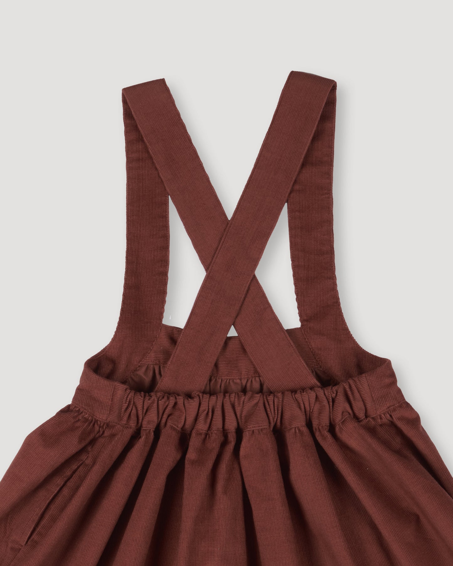 Early Sunday, Annie Skirt in Caramel color, made from Cotton Corduroy fabric, featuring a relaxed fit with an elastic waistband & beautiful embroidery, shown in a closeup flat-lay view