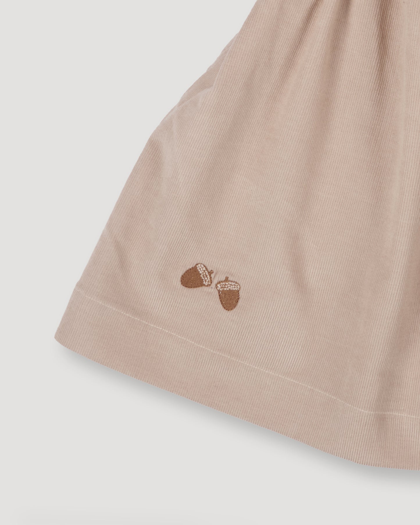 Early Sunday, Annie Skirt in Beige color, made from Cotton Corduroy fabric, featuring a relaxed fit with an elastic waistband & beautiful embroidery, shown in a close-up shot of the print