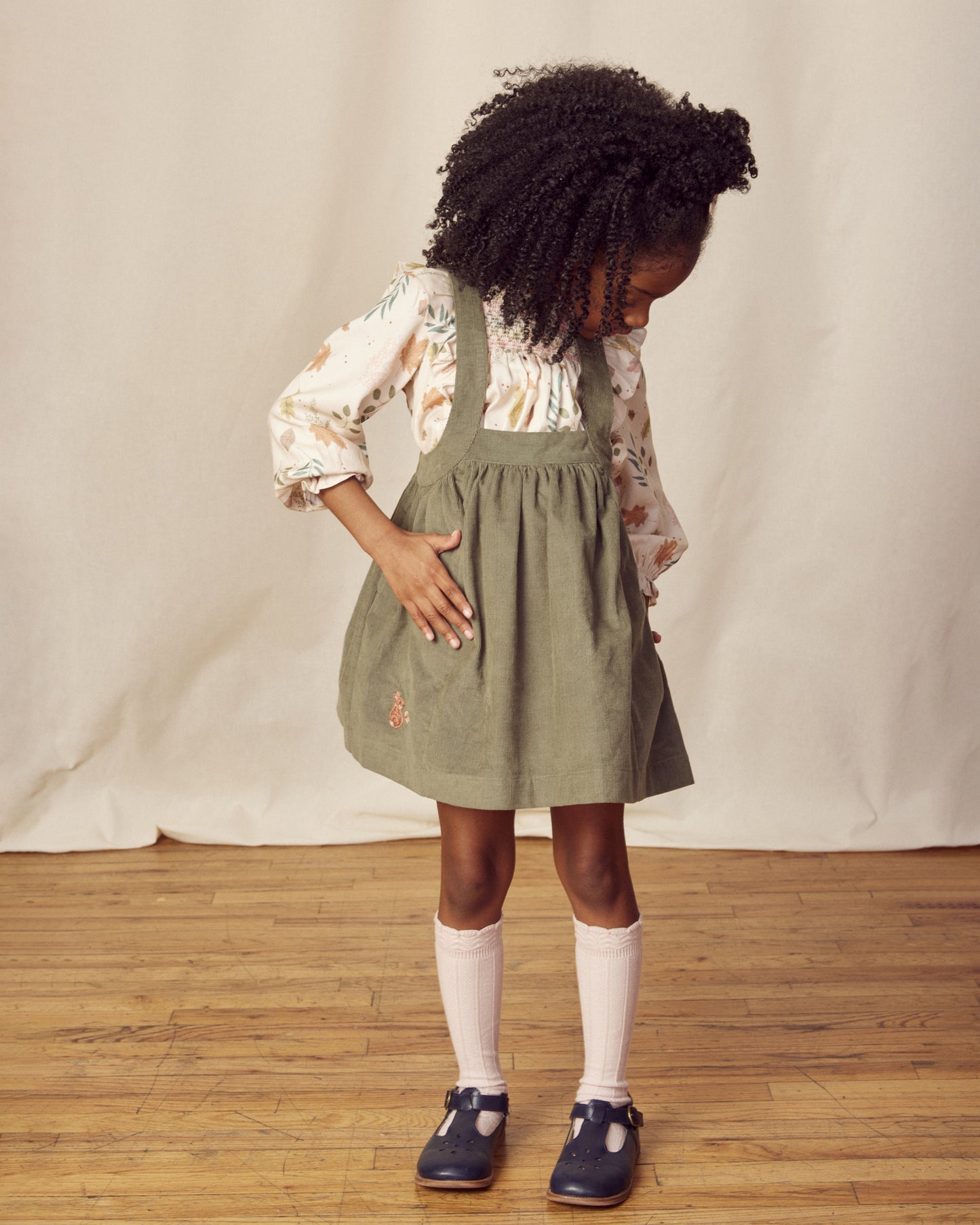 Early Sunday, Annie Skirt in Moss color, made from Cotton Corduroy fabric, featuring a relaxed fit with an elastic waistband & beautiful embroidery, shown in a front view of model wearing it