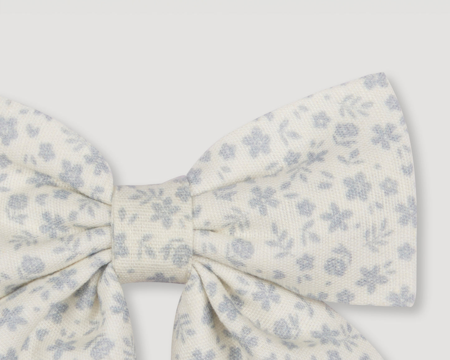 Early Sunday, Audrey Alligator Clip in Mini Flower print, made from Printed canvas 70% Cotton 30% Linen fabric, featuring a fabric bow design with a secure hair clip fastening, shown in a closeup flat-lay view