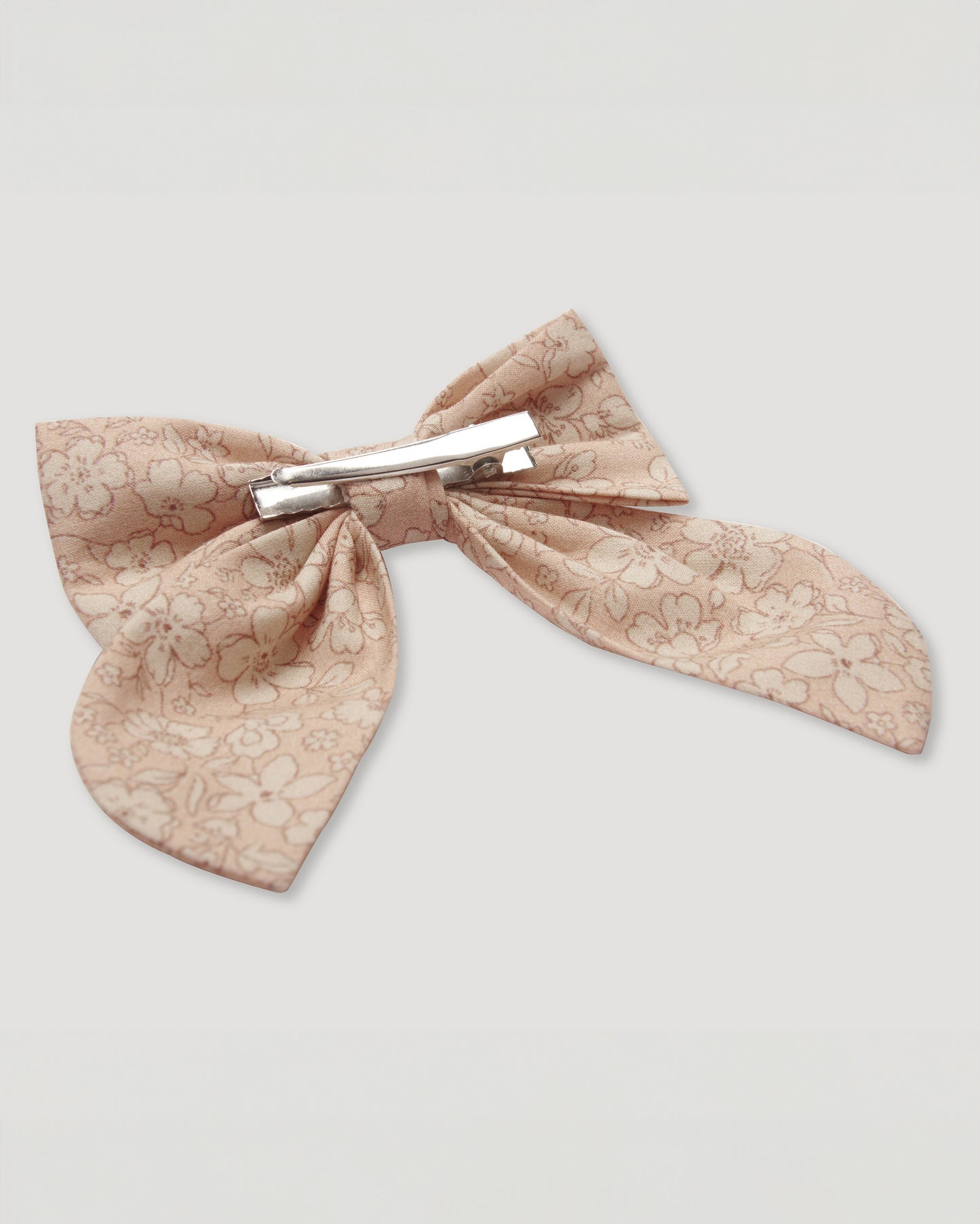 Early Sunday, Audrey Alligator Clip in Garden Flowers print, made from Printed Cotton Cambric fabric, featuring a fabric bow design with a secure hair clip fastening, shown in a closeup flat-lay view