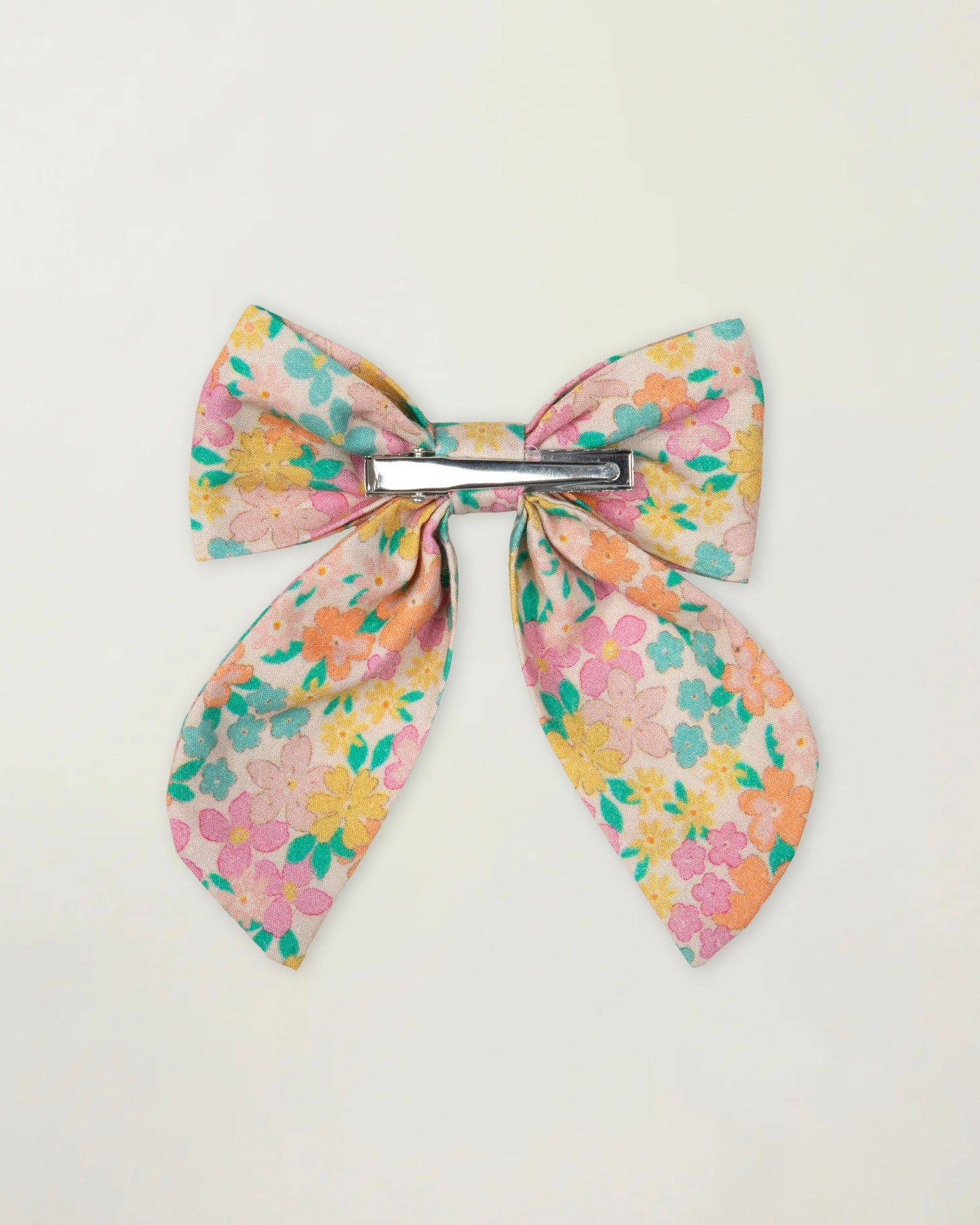 Early Sunday, Audrey Clip in Emma Floral Mint color, made from Organic Printed Cotton Cambric fabric, featuring a fabric bow design with a secure hair clip fastening, shown in a back flat-lay view