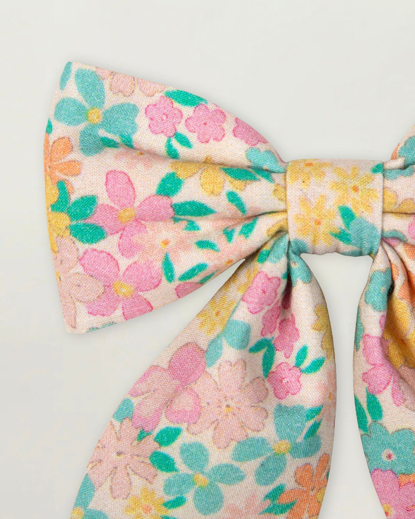 Early Sunday, Audrey Clip in Emma Floral Mint color, made from Organic Printed Cotton Cambric fabric, featuring a fabric bow design with a secure hair clip fastening, shown in a closeup flat-lay view