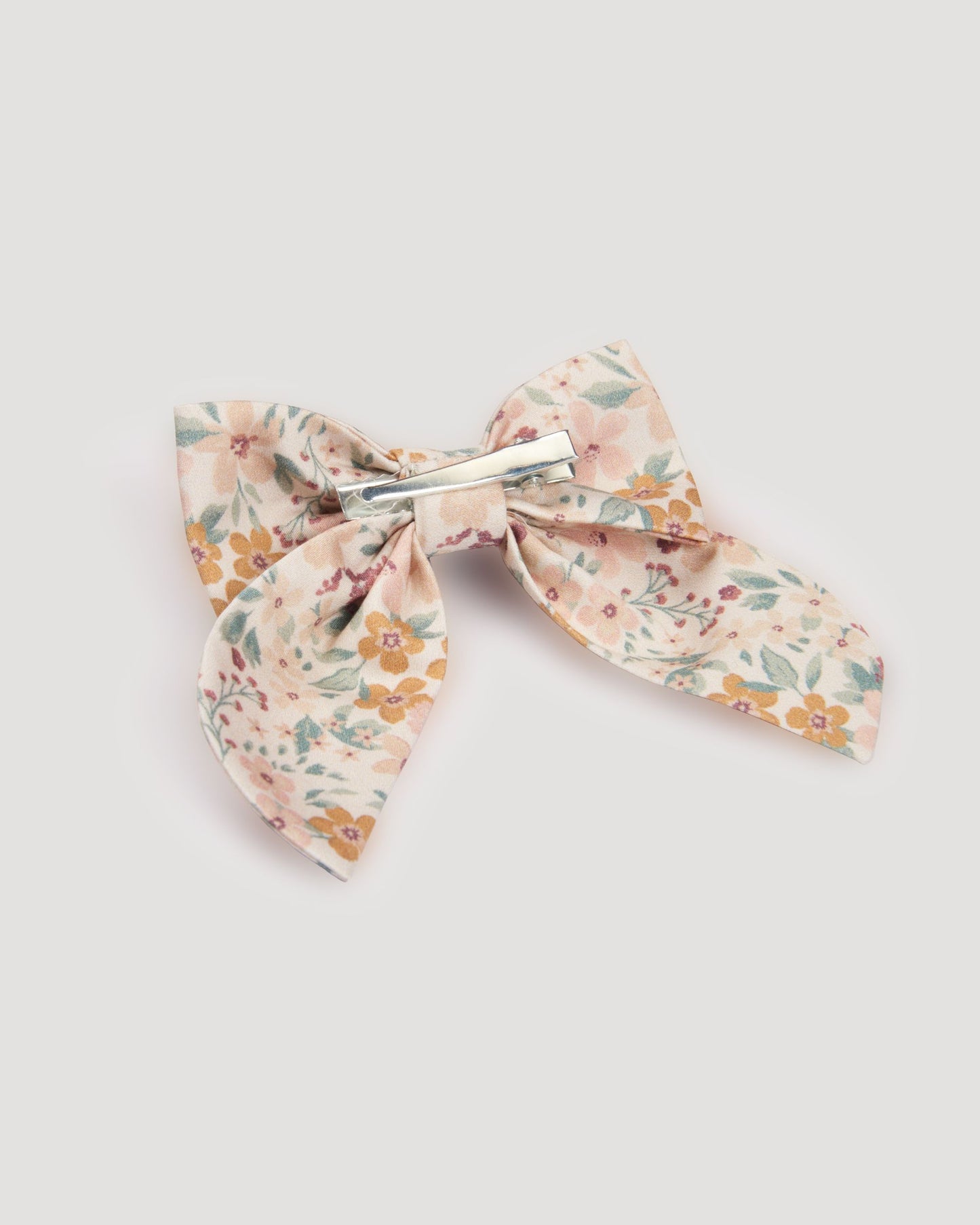 Early Sunday, Audrey Clip in Floral print, made from Printed 60s Cotton Satin fabric, featuring a fabric bow design with a secure hair clip fastening, shown in a back flat-lay view