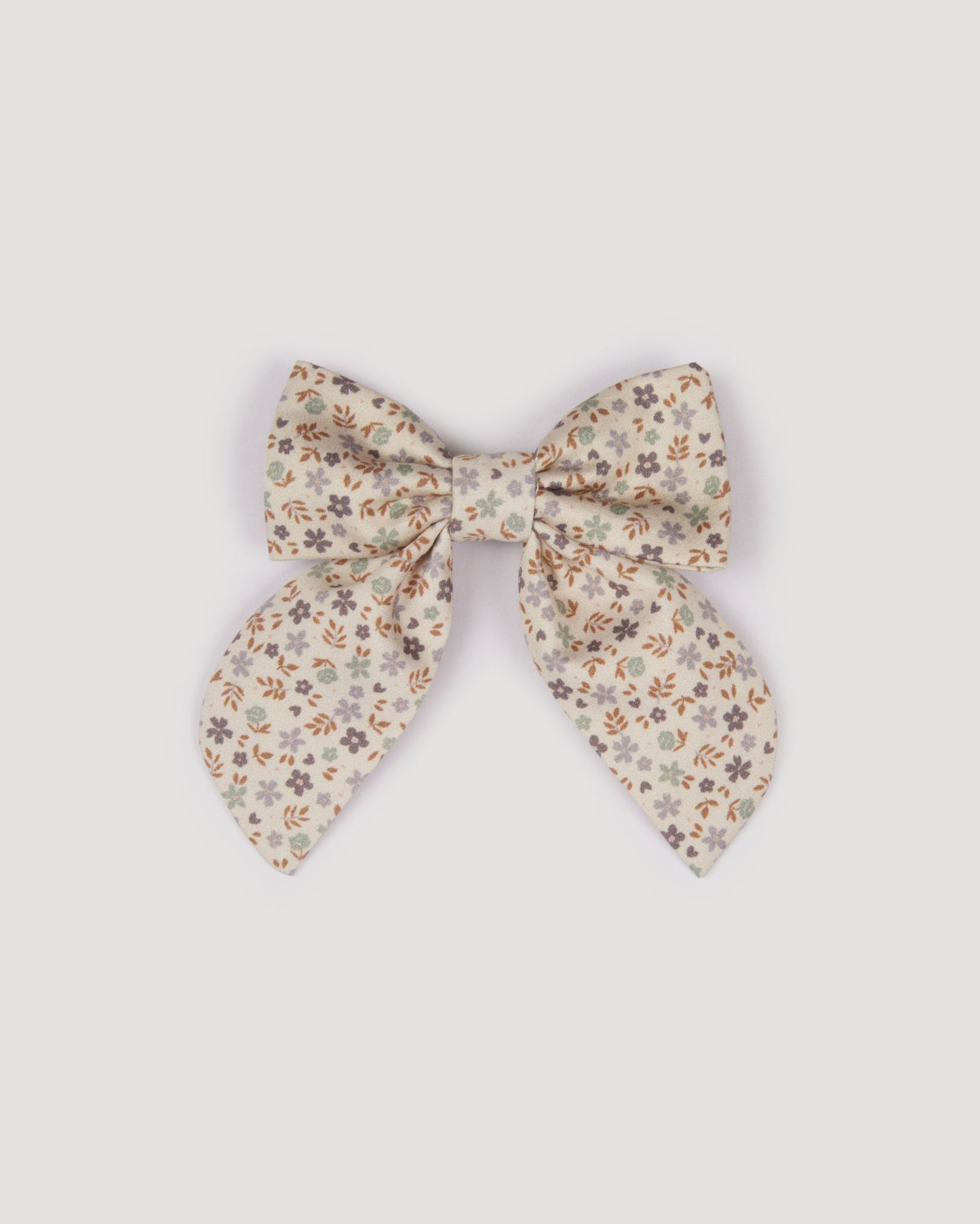 Early Sunday, Audrey Clip in Mini Flowers print, made from Printed 60s Cotton Satin fabric, featuring a fabric bow design with a secure hair clip fastening, shown in a front flat-lay view