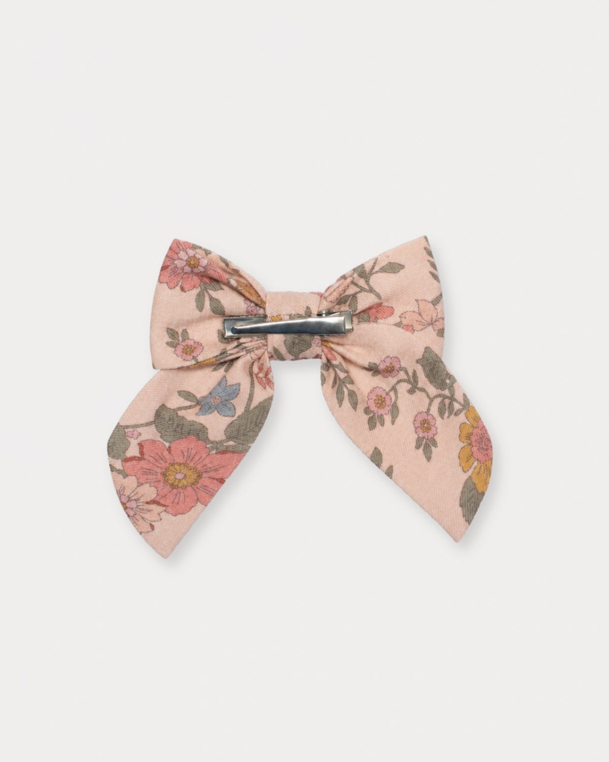 Early Sunday, Audrey Clip in Bloom Blush, made from Printed Viscose Twill fabric, featuring a fabric bow design with a secure hair clip fastening, shown in a back flat-lay view