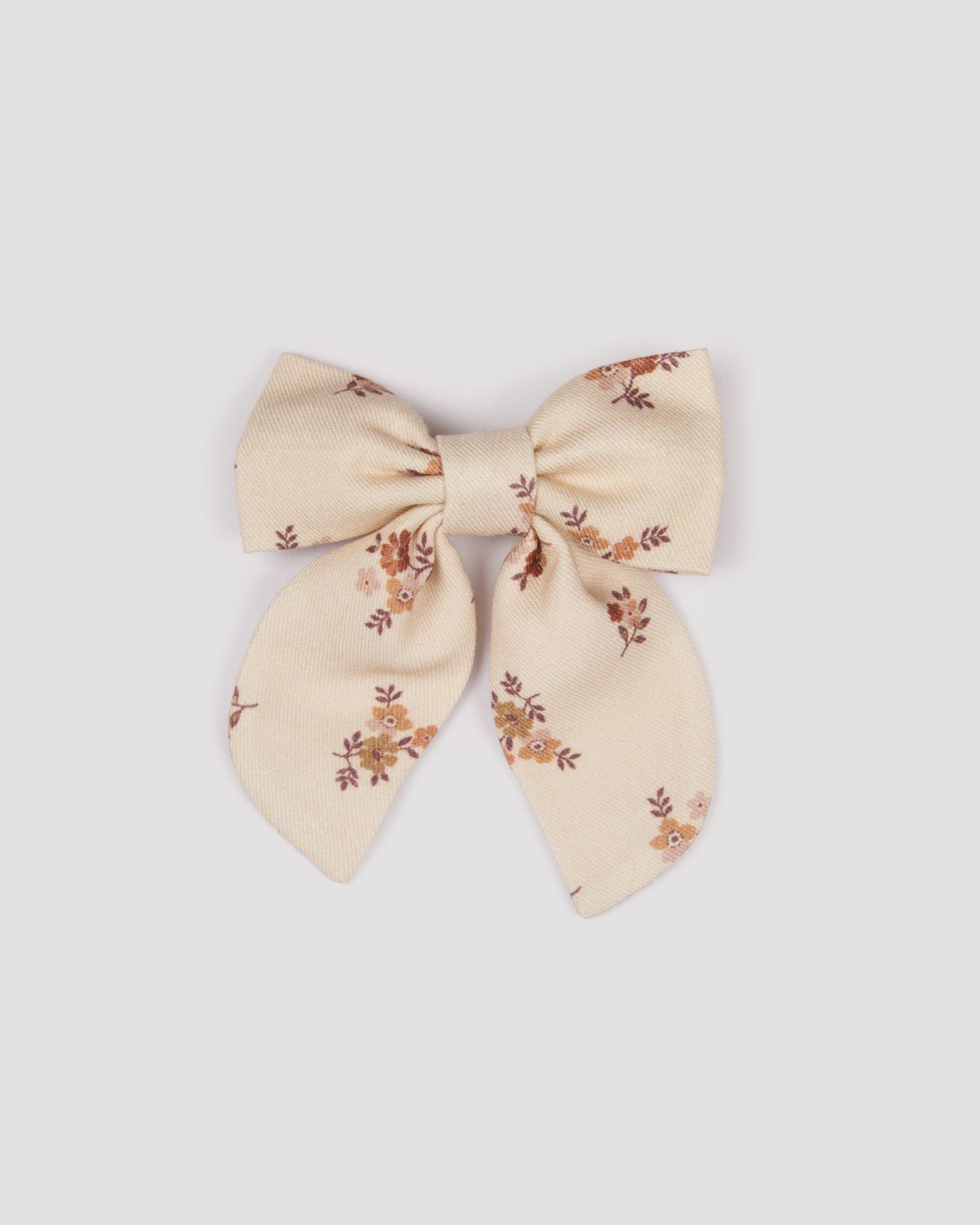 Early Sunday, Audrey Clip in Ditsy Bouquet Cream print, made from Printed Viscose Twill fabric, featuring a fabric bow design with a secure hair clip fastening, shown in a front flat-lay view