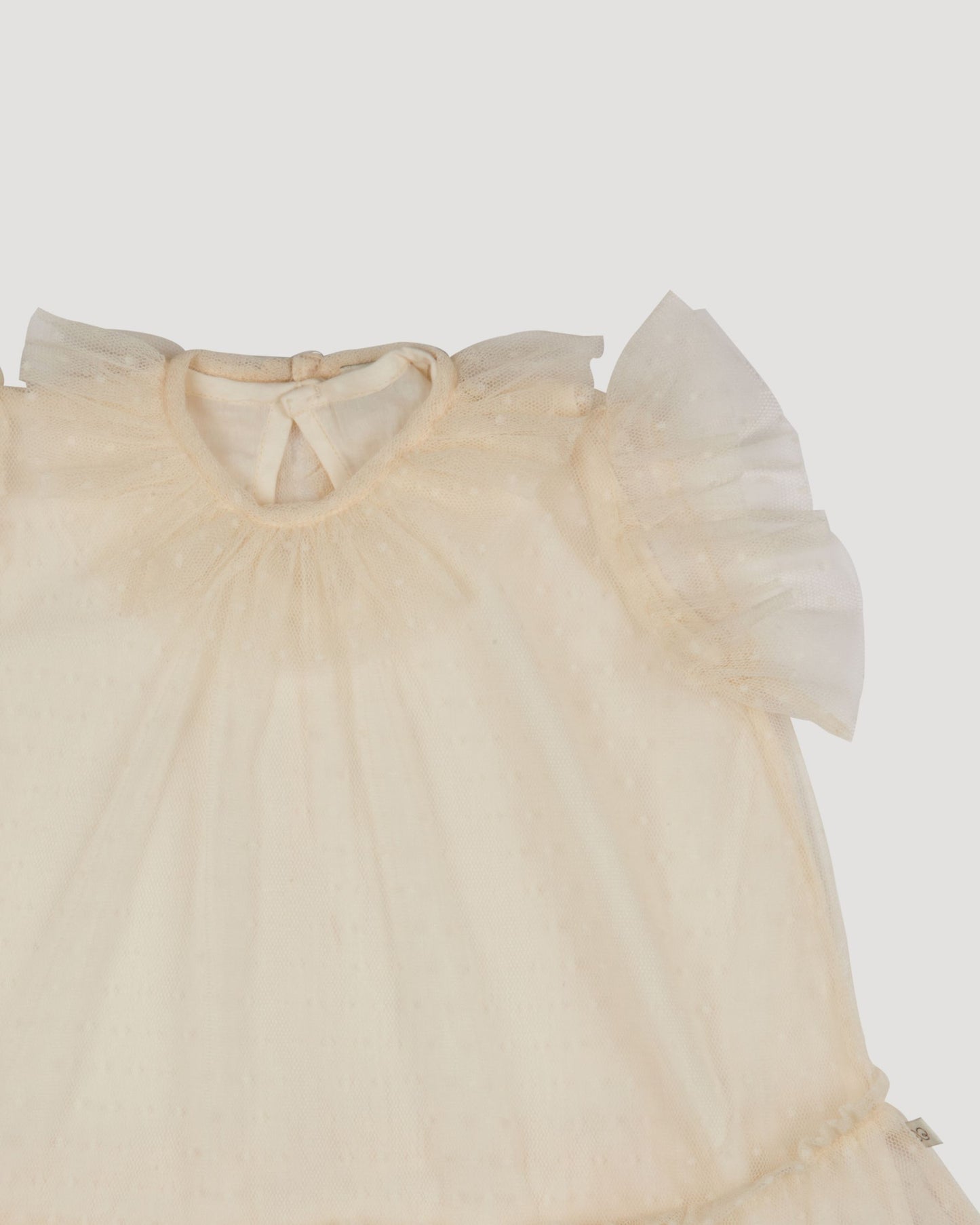 Early Sunday, Aurelia Dress in Hazelnut Cream, made from Dyed Nylon Mesh Dobby fabric, featuring Layered ruffles with flutter sleeves, shown in a closeup flat-lay view