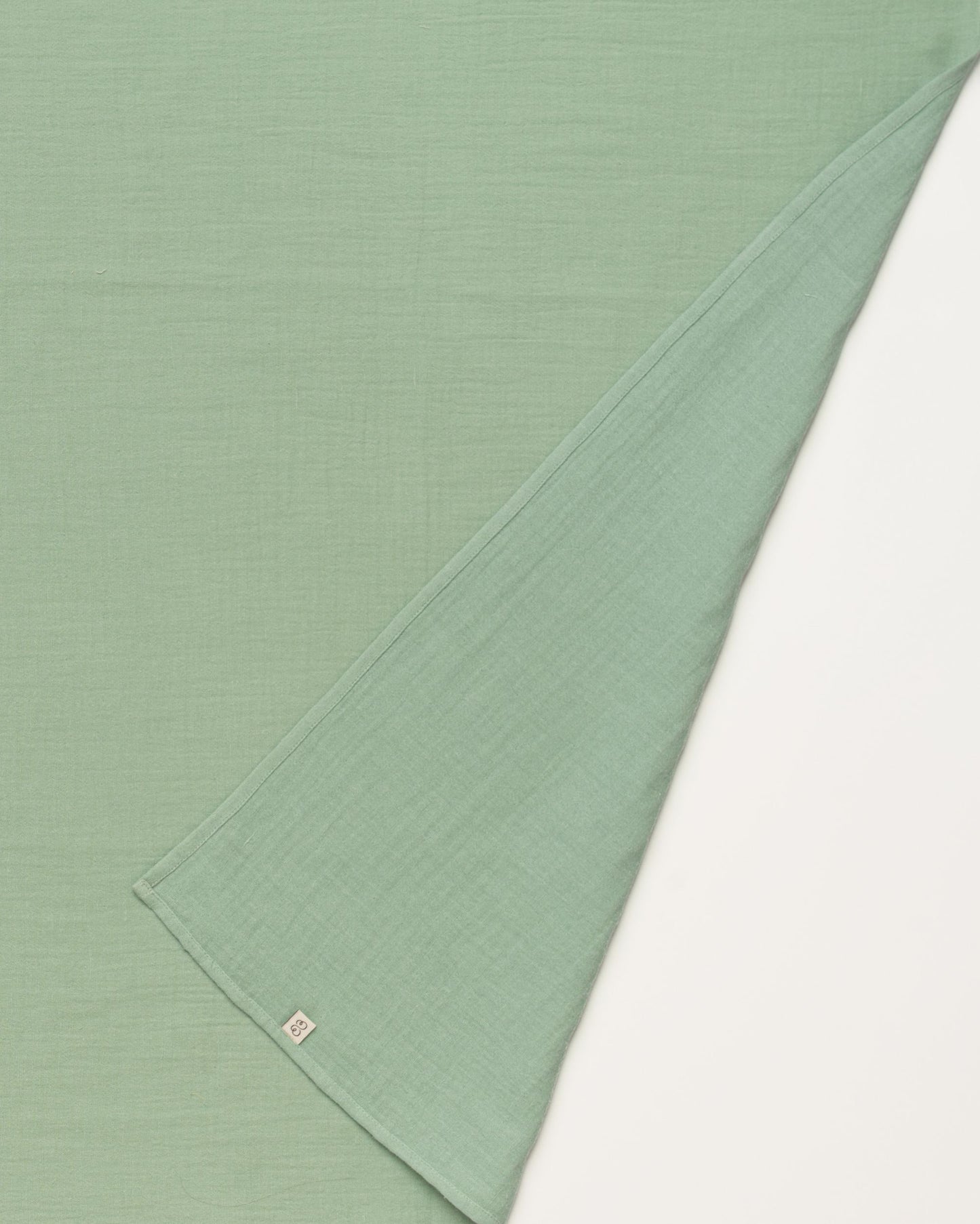 Early Sunday, Baby Napkin in Mint color, made from Printed Cotton Double Gauze fabric, shown in a closeup flat-lay view