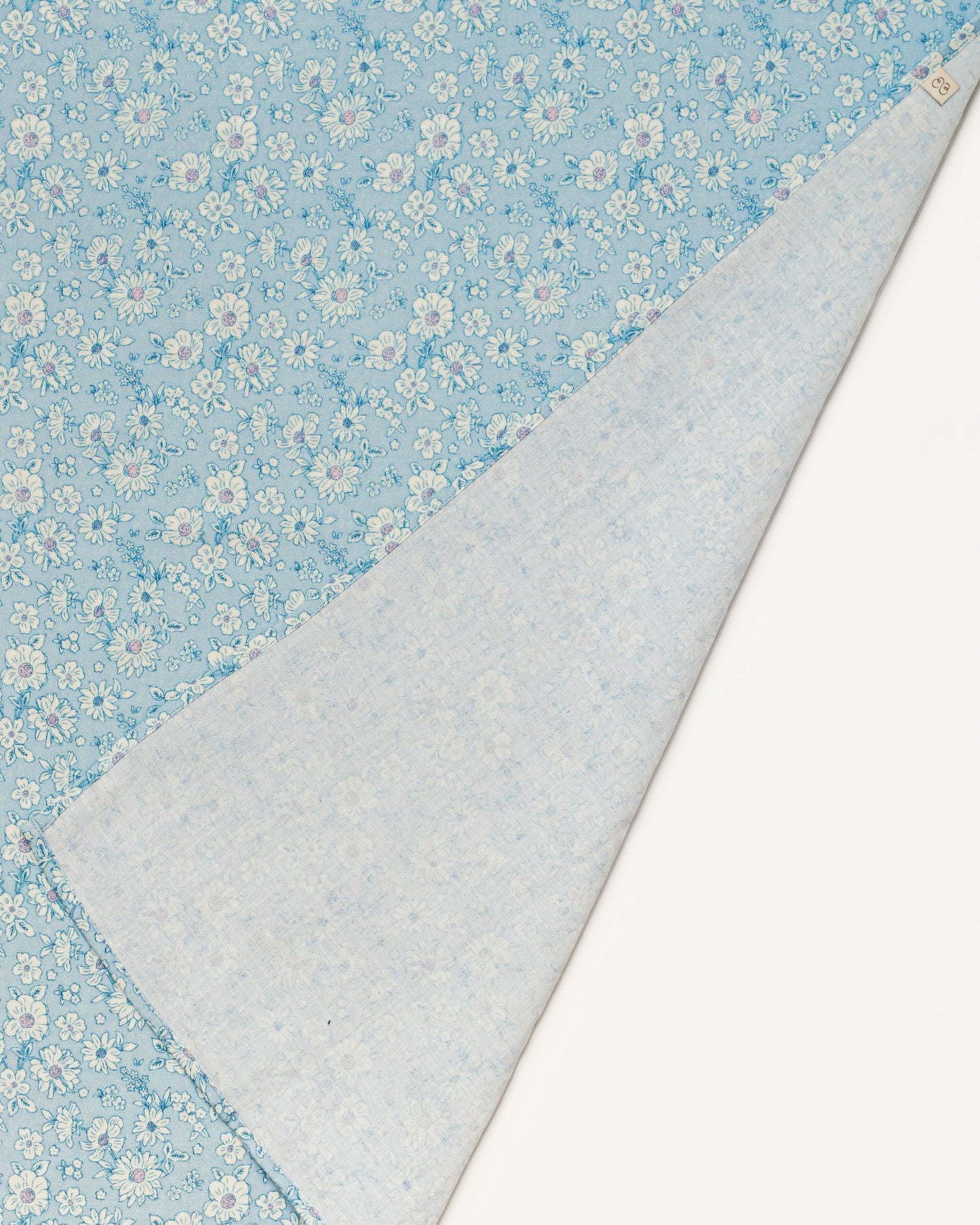 Early Sunday, Baby Napkin in Tonal Floral Blue color, made from Printed Cotton Double Gauze fabric, shown in a closeup flat-lay view