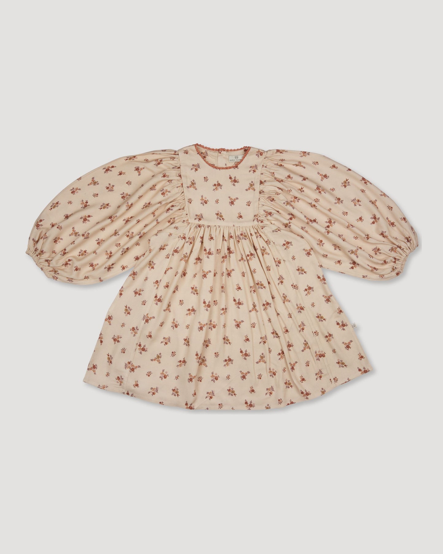 Early Sunday, Belle Dress in Ditsy Bouquet Cream print, made from Printed Viscose Rayon Twill fabric, featuring Hand-embroidered floral bodice with voluminous puff sleeves for a soft, enchanting silhouette, shown in a front flat-lay view