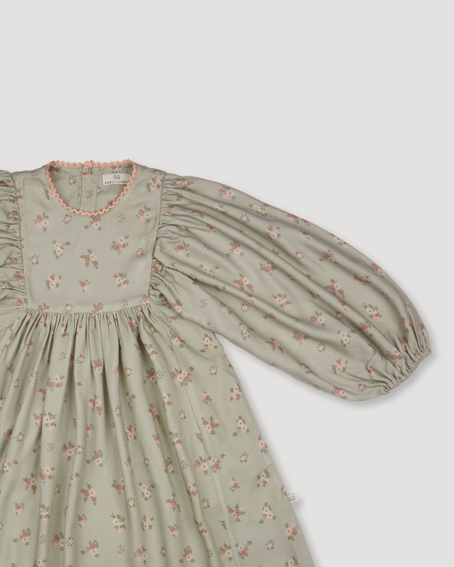 Early Sunday, Belle Dress in Ditsy Bouquet Jade print, made from Printed Viscose Rayon Twill fabric, featuring Hand-embroidered floral bodice with voluminous puff sleeves for a soft, enchanting silhouette, shown in a closeup flat-lay view