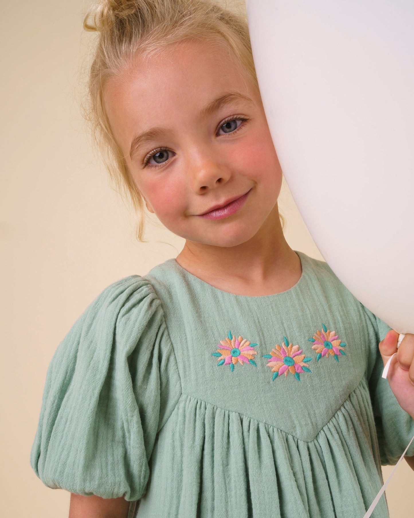 Early Sunday, Beth Dress in Mint color, made from 100% cotton double gauze solid fabric, featuring Puff sleeves, contrast scalloped collar for a vintage touch, shown in a close up shot of model wearing it.