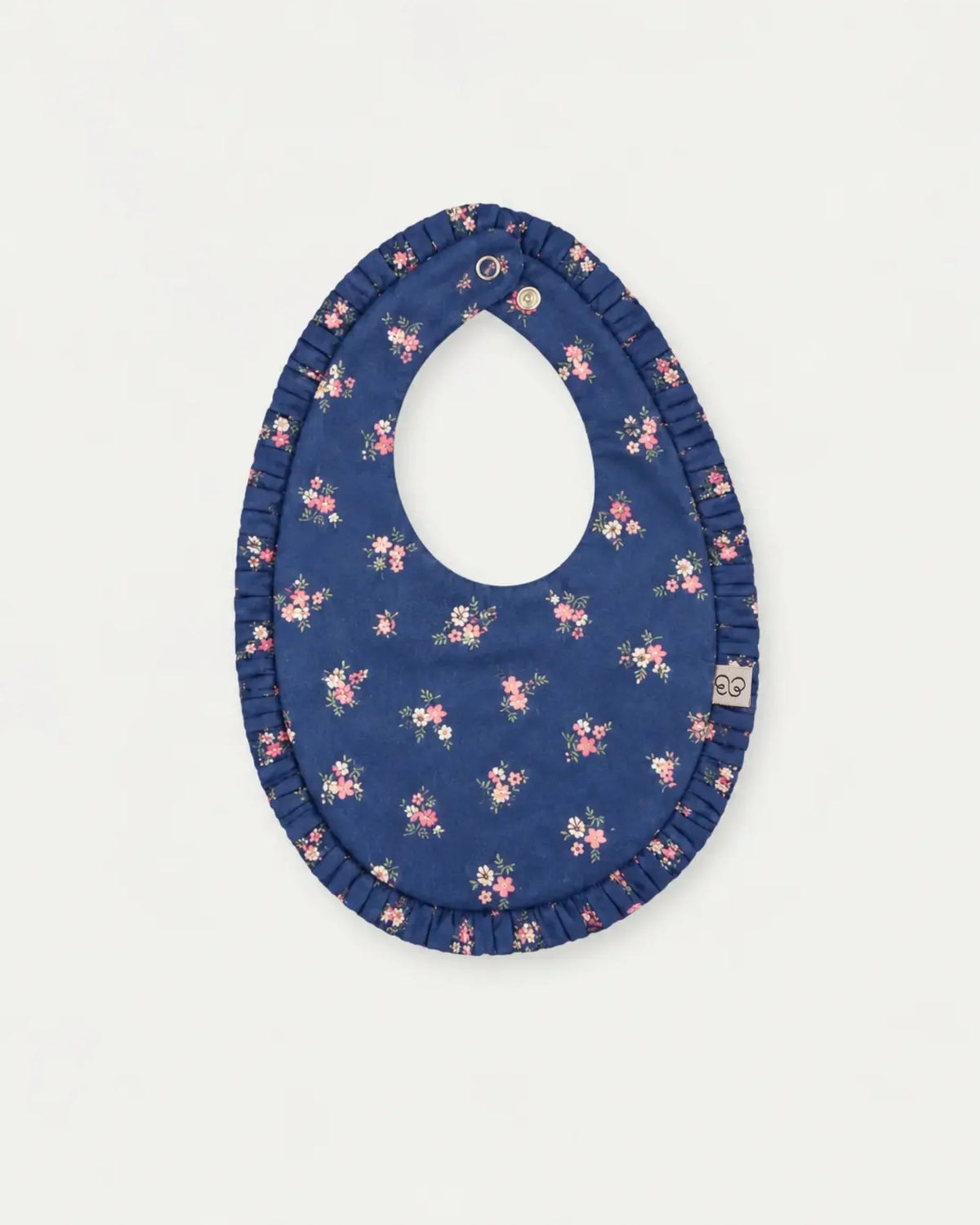 Early Sunday, Bib in Ditsy Bouquet Navy Blue, made from Printed Cotton Satin fabric, featuring a soft and comfortable design with an adjustable fit, shown in a front flat-lay view
