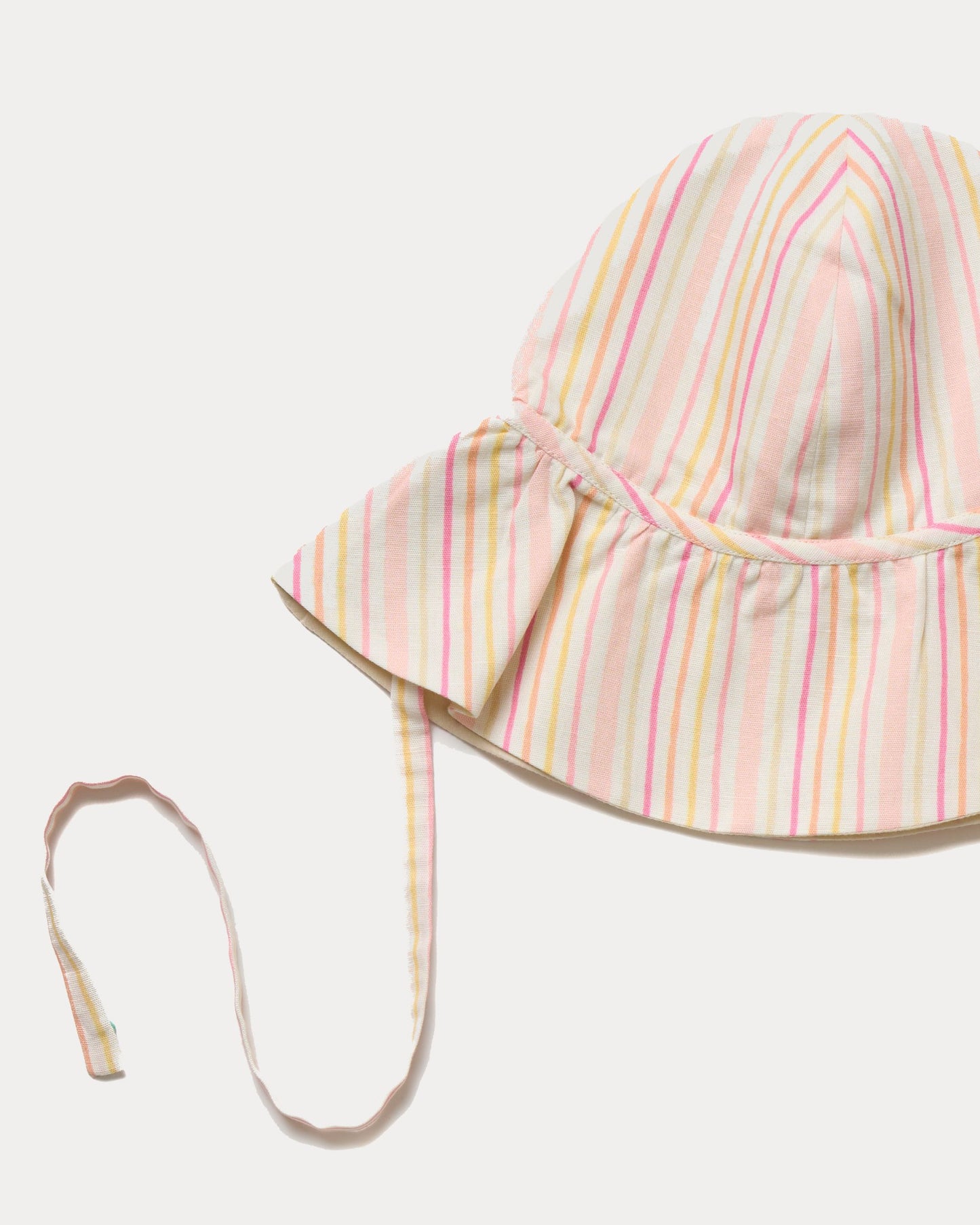 Early Sunday, Bonnie Hat Cap in Pink Stripes print, made from 70% Cotton, 30% Linen fabric, shown in a closeup flat-lay view