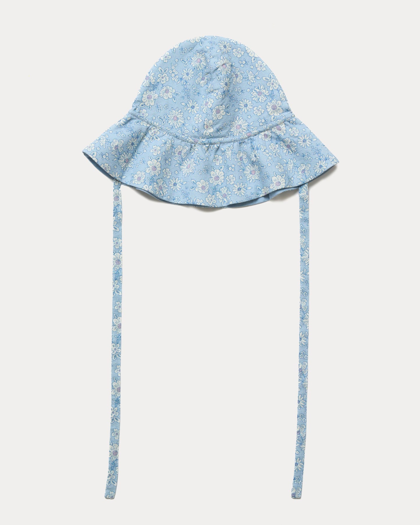 Early Sunday, Bonnie Hat Cap in Tonal Floral Blue color, made from Printed Tiny Swiss Dobby fabric, shown in a front flat-lay view with wide brim and tie straps