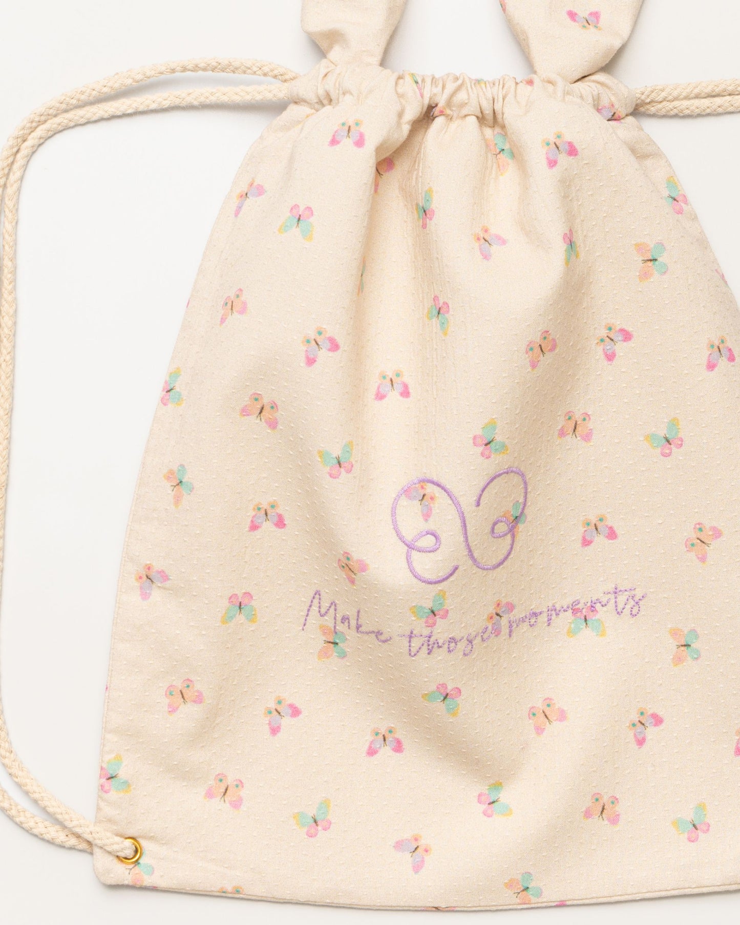 Early Sunday, Bunny Drawstring Backpack in Butterflies print, made from Printed Cotton Tiny Swiss Dobby fabric, featuring a bunny-ear design with a drawstring closure, shown in a closeup flat-lay view