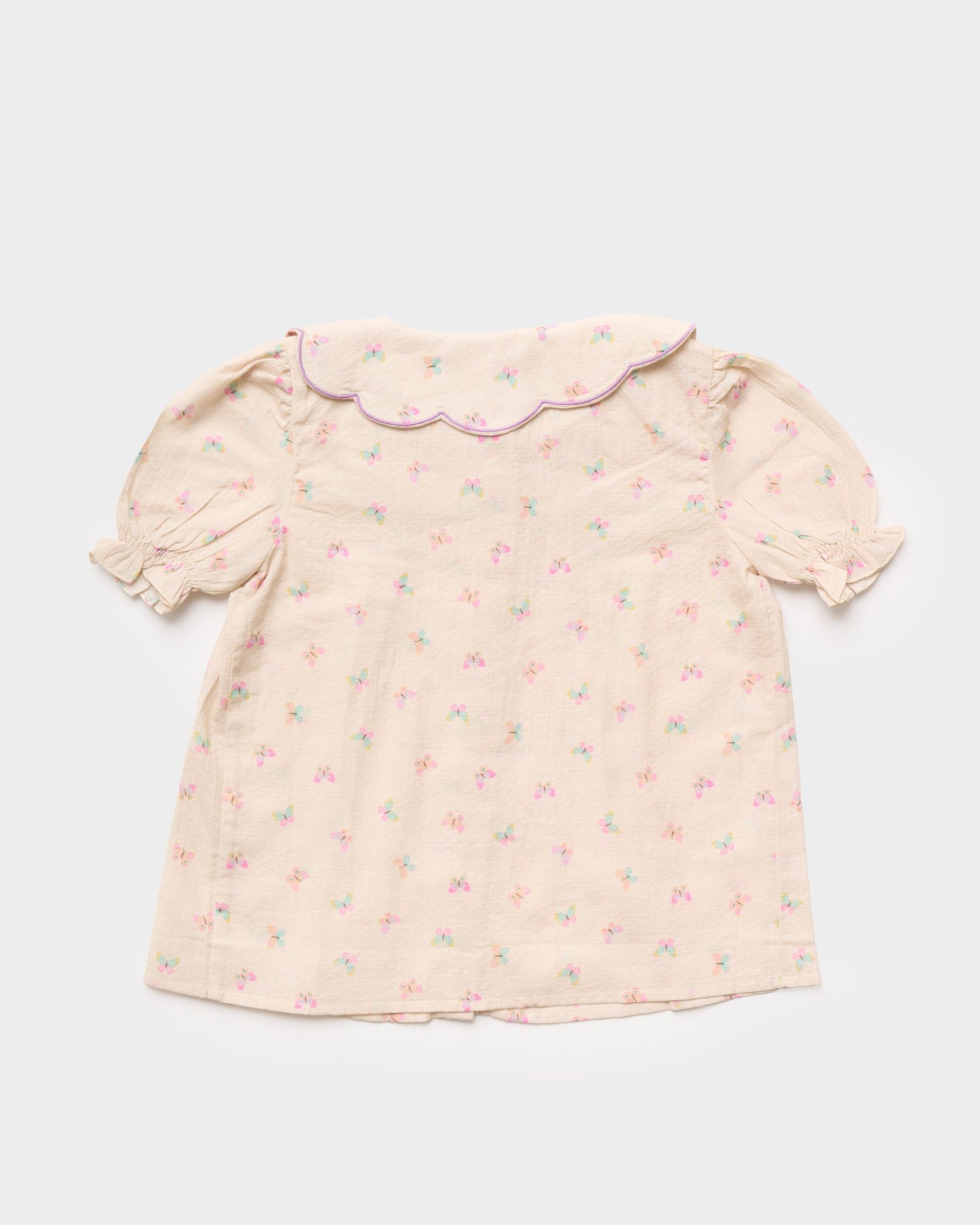 Early Sunday, Camelia Blouse in Butterfly Print color, made from printed cotton tiny swiss dobby fabric, featuring short sleeves with peter pan collar, shown in a back flat-lay view