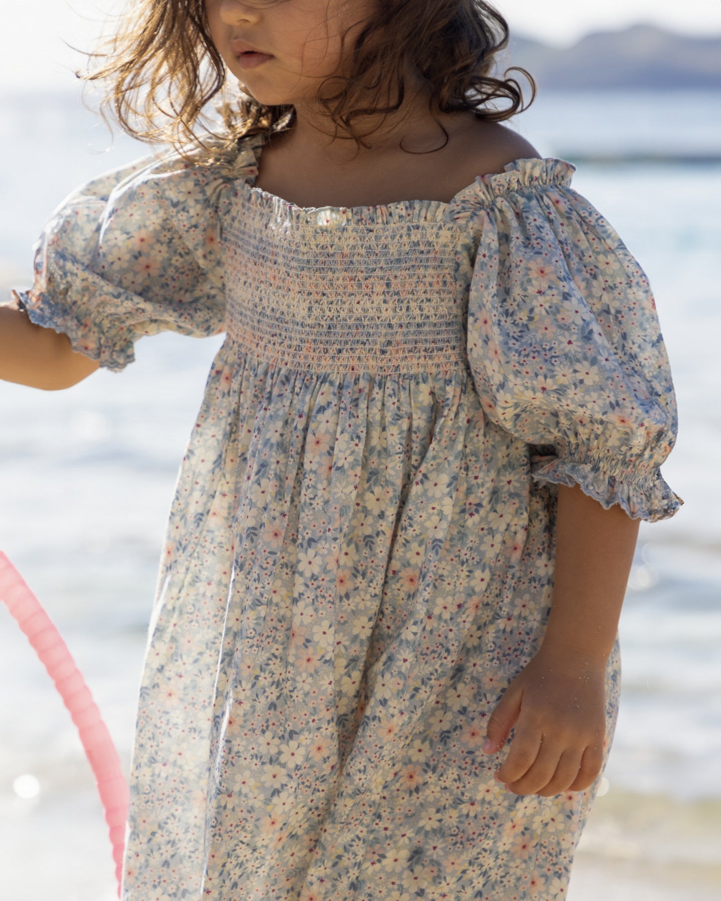 Early Sunday, Caroline Dress in Amelia print, made from Printed Cotton Cambric fabric, featuring tiered silhouette with thoughtful details for a feminine and relaxed look, shown in a close-up side view of a model wearing it