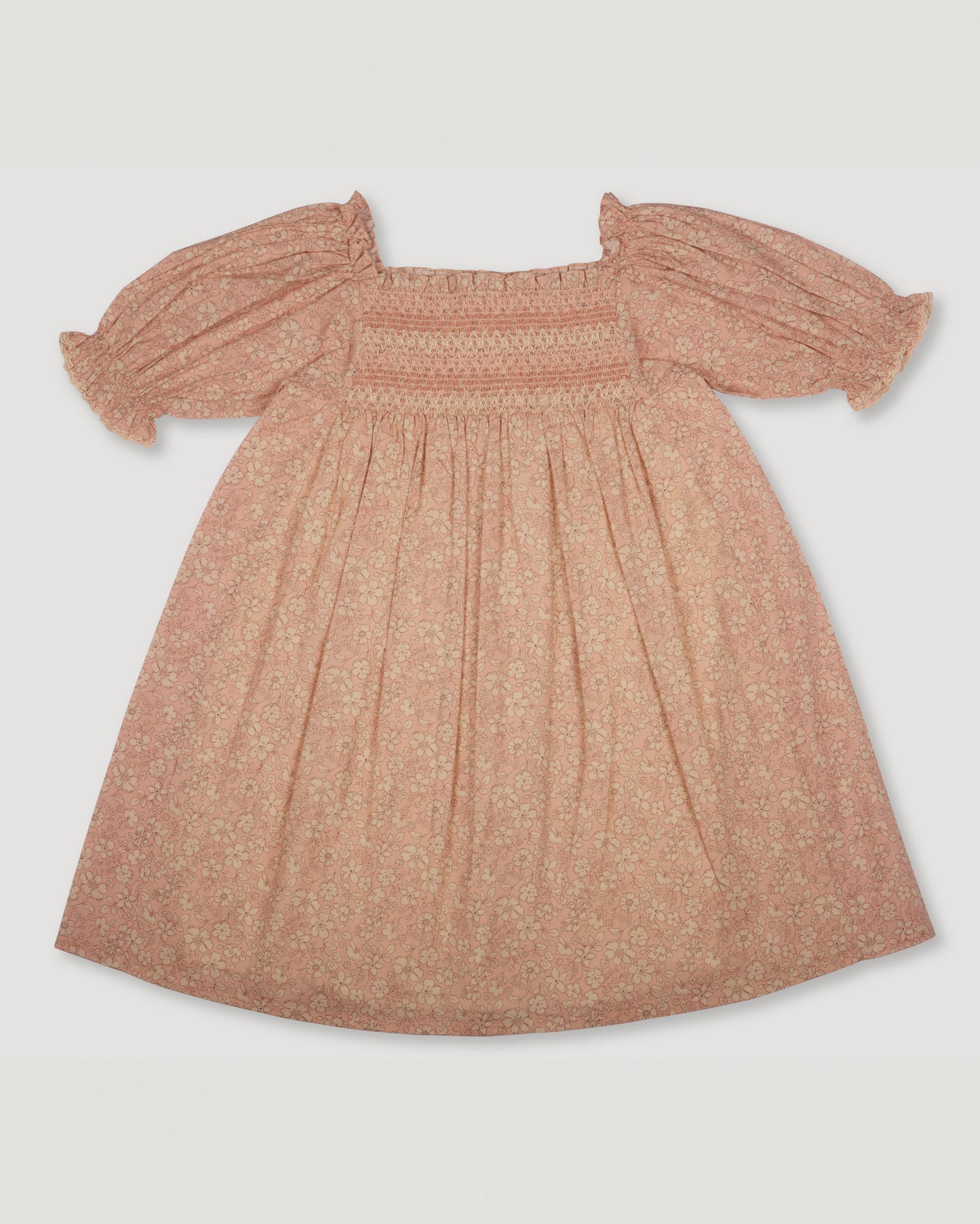 Early Sunday, Caroline Dress in Garden Flowers print color, made from Printed Cotton Cambric fabric, featuring tiered silhouette with thoughtful details for a feminine and relaxed look, shown in a back flat-lay view
