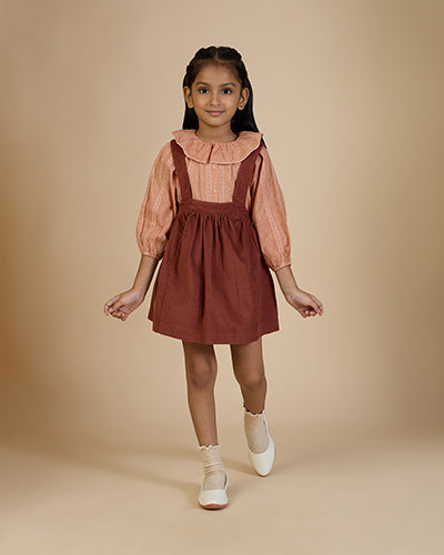 Early Sunday, Cecilia Blouse in Earthy Pink print, made from Cotton Swiss Dobby fabric, featuring relaxed fit, frill neckline, long sleeves with elasticated cuffs, and MOP buttons, shown in a front view of model wearing it
