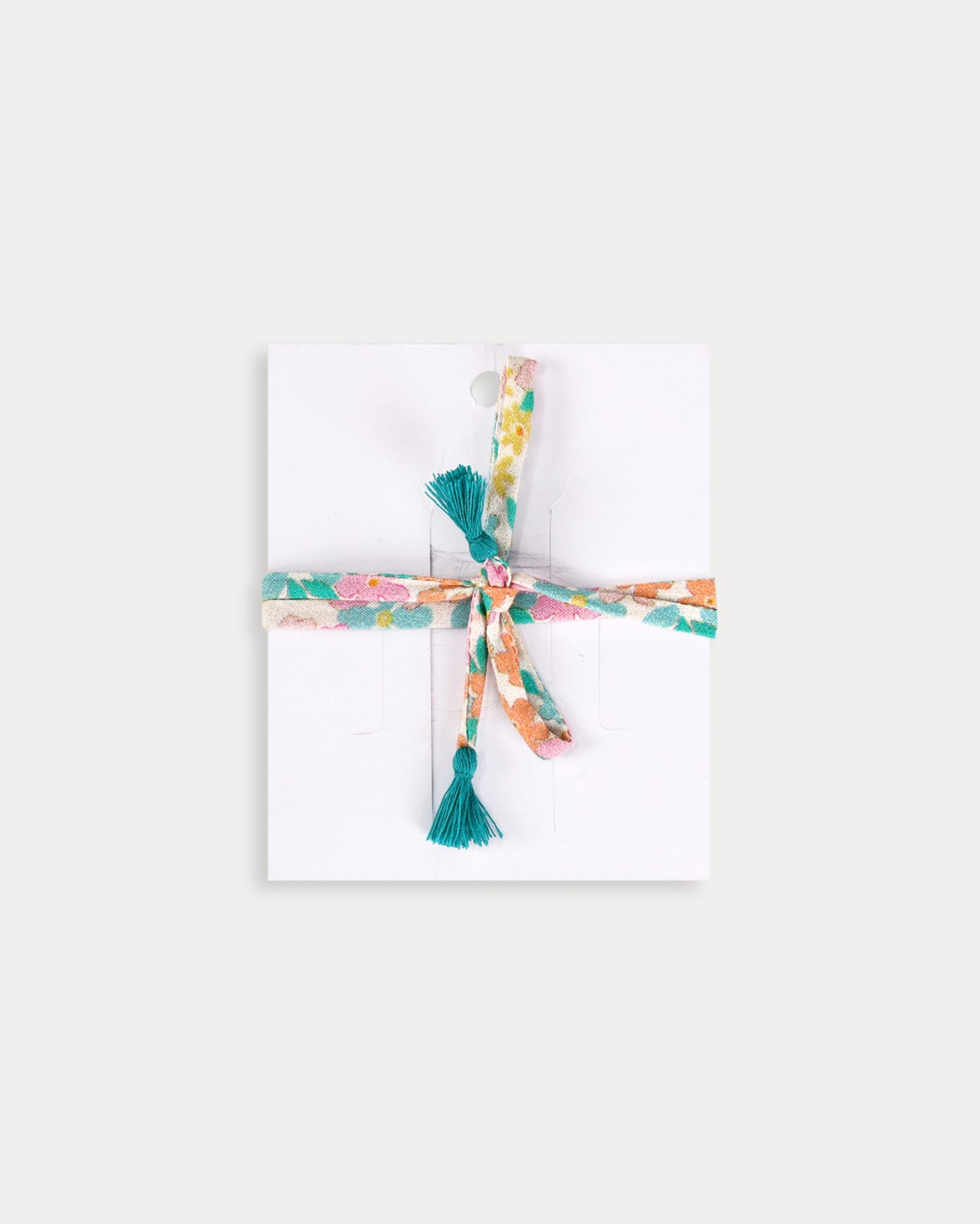 Early Sunday, Charm Bracelet in Emma Floral Mint color, made from Organic Printed Cotton Cambric fabric, featuring a soft fabric bracelet design with a charm, shown in a back flat-lay view
