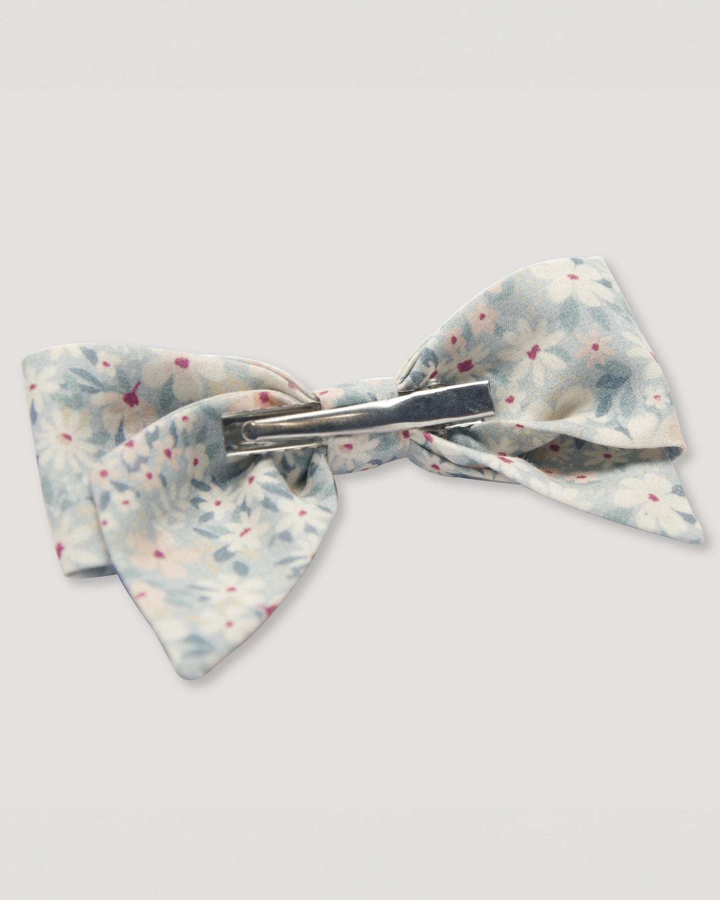 Early Sunday, Chiara Alligator Clip in Amelia print, made from Printed Cotton Cambric fabric, featuring a bow design on an alligator clip with a secure fit, shown in a back flat-lay view