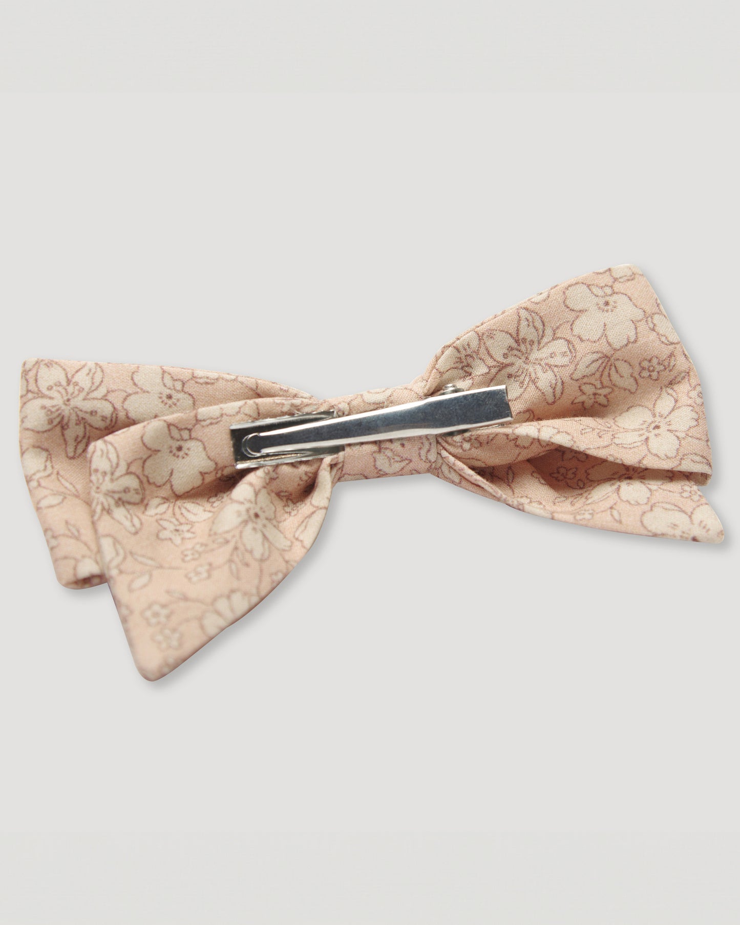Early Sunday, Chiara Alligator Clip in Garden Flowers print, made from Printed Cotton Cambric fabric, featuring a bow design on an alligator clip with a secure fit, shown in a back flat-lay view