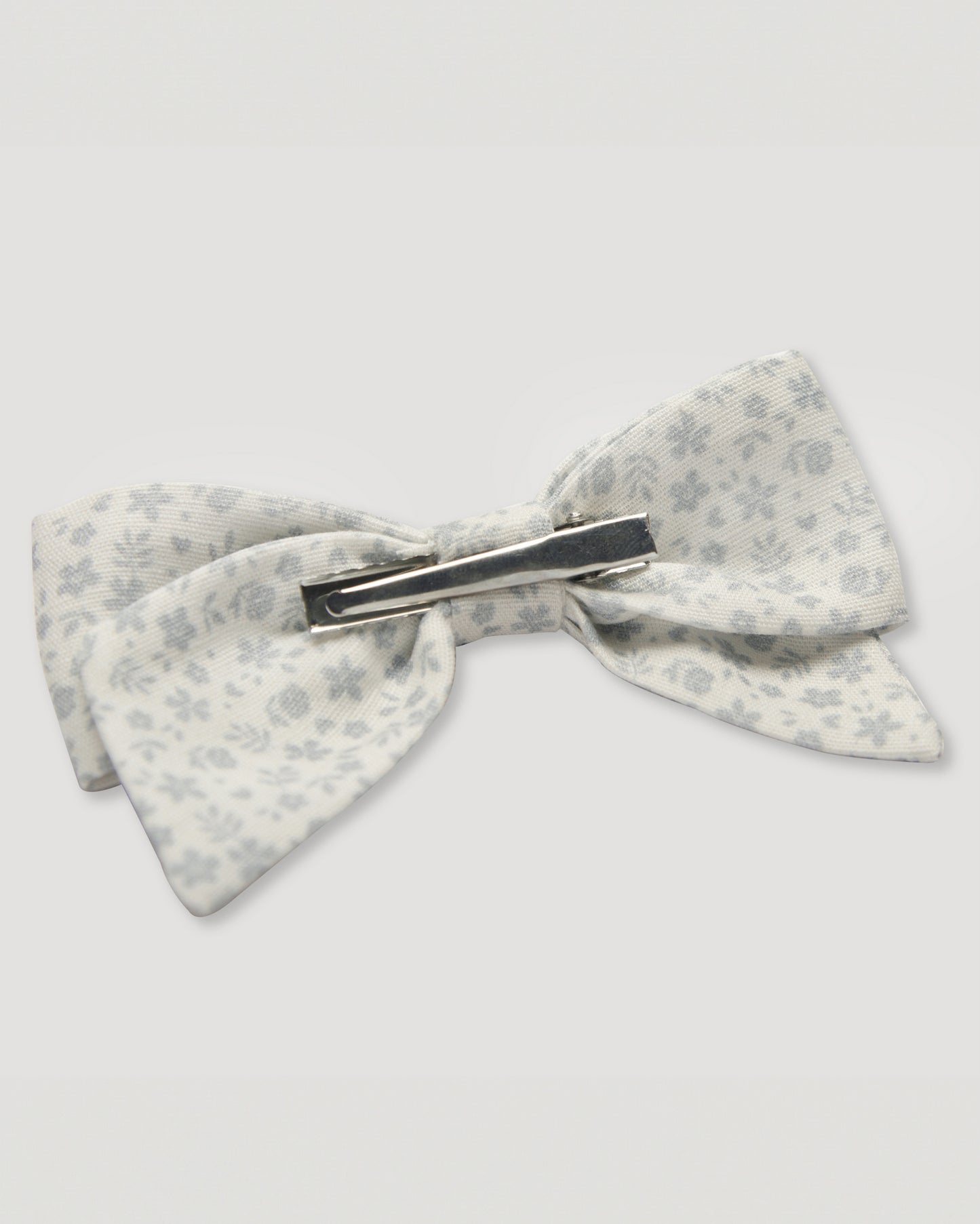 Early Sunday, Chiara Alligator Clip in Mini Flower print, made from Printed Cotton Cambric fabric, featuring a bow design on an alligator clip with a secure fit, shown in a back flat-lay view