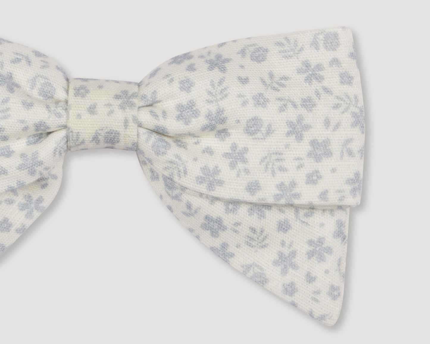 Early Sunday, Chiara Alligator Clip in Mini Flower print, made from Printed Cotton Cambric fabric, featuring a bow design on an alligator clip with a secure fit, shown in a closeup flat-lay view