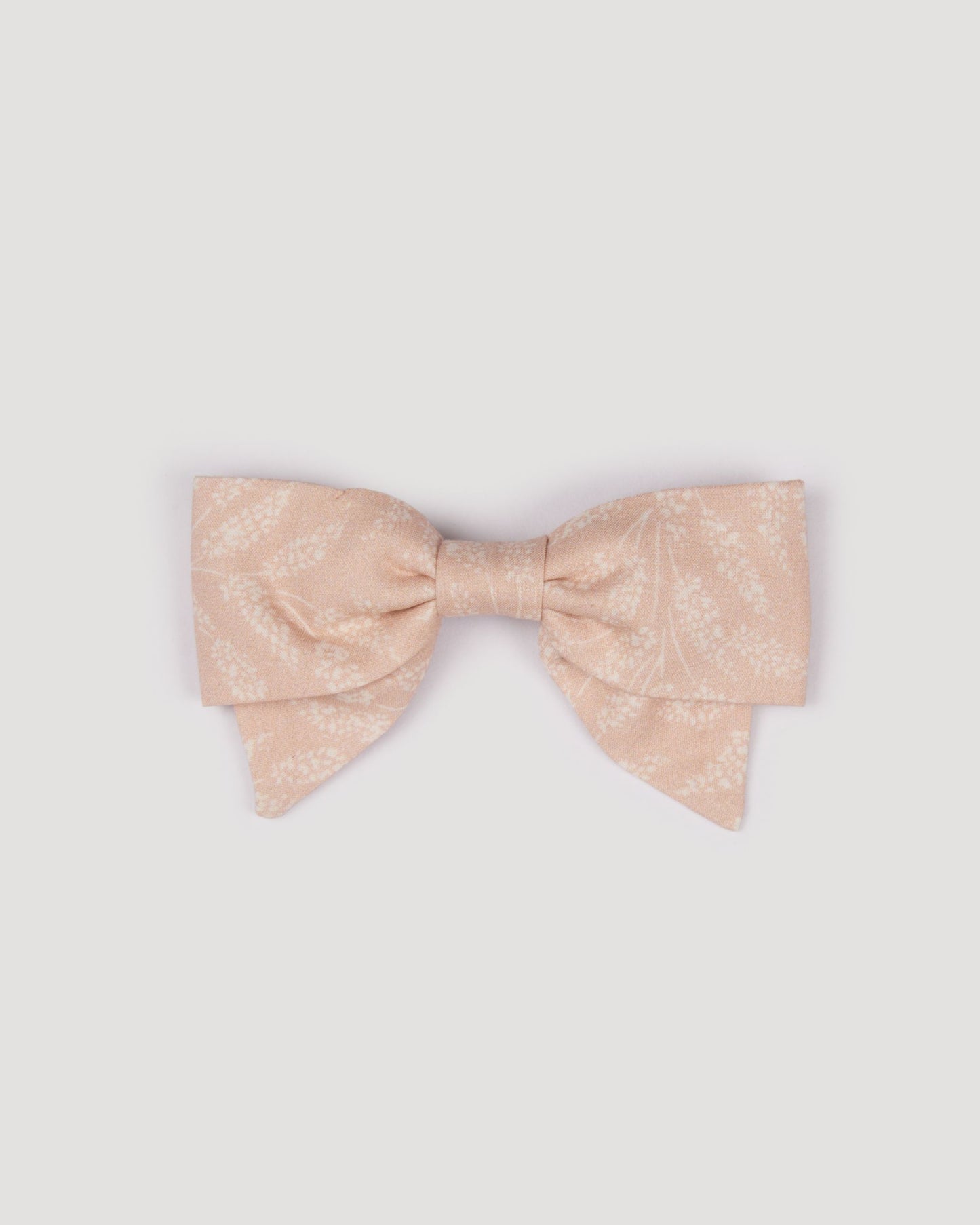 Early Sunday, Chiara Clip in Feather print, made from Printed 60s Cotton Cambric fabric, featuring a bow design on an alligator clip with a secure fit, shown in a front flat-lay view