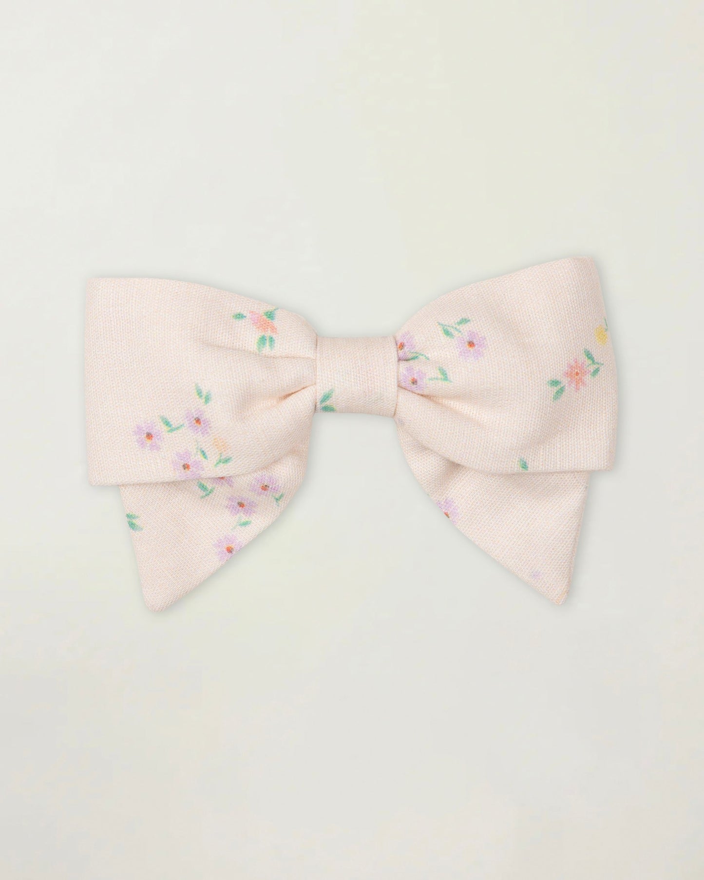 Early Sunday, Chiara Clip in Painted Bouquet print, made from Printed 70% Cotton, 30% Linen fabric, featuring a bow design on an alligator clip with a secure fit, shown in a front flat-lay view