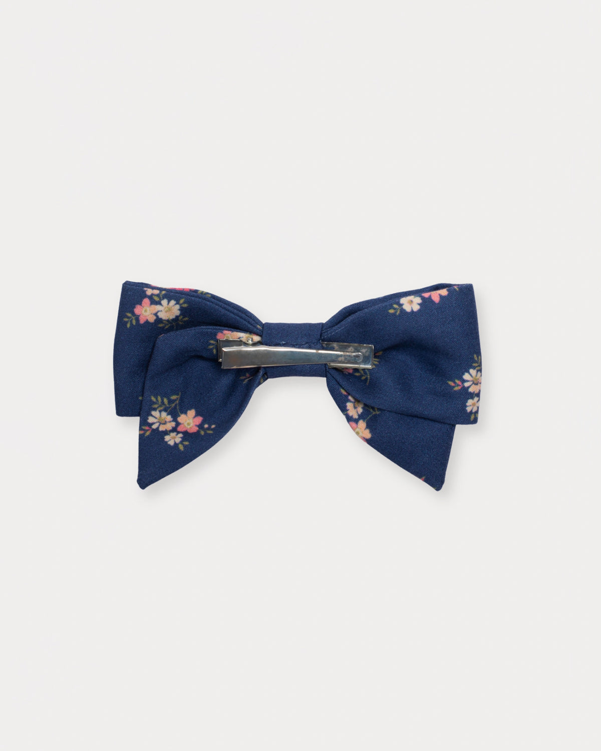 Early Sunday, Chiara Clip in Ditsy Bouquet Navy Blue, made from Printed Cotton Satin fabric, featuring a bow design on an alligator clip with a secure fit, shown in a back flat-lay view