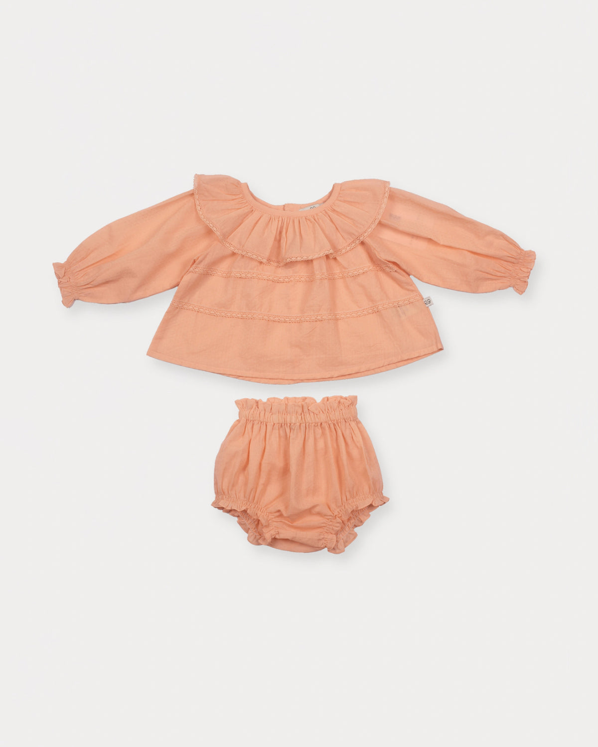 Early Sunday, Daisy Baby Blouse & Bloomer Set in Dusty Pink, made from Cotton Dobby Spot fabric, featuring a frilly neckline & detailed lace yoke with matching bloomer, shown in a front flat-lay view