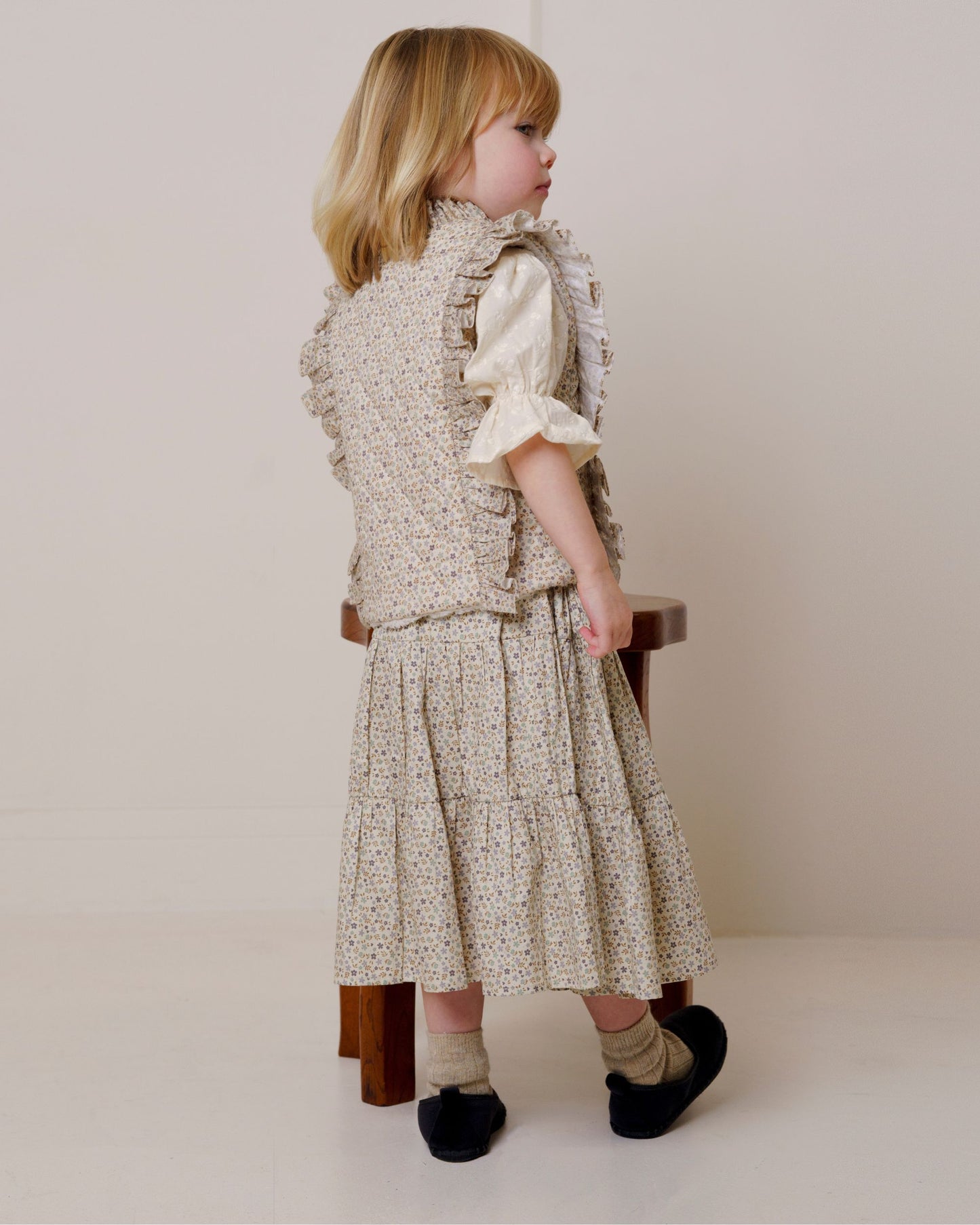 Early Sunday, Deborah Jacket in Miny Flowers print, made from Printed 30s Cotton Twill fabric, featuring Sleeveless design ideal for versatile layering in transitional weather, shown in a back view of model wearing it