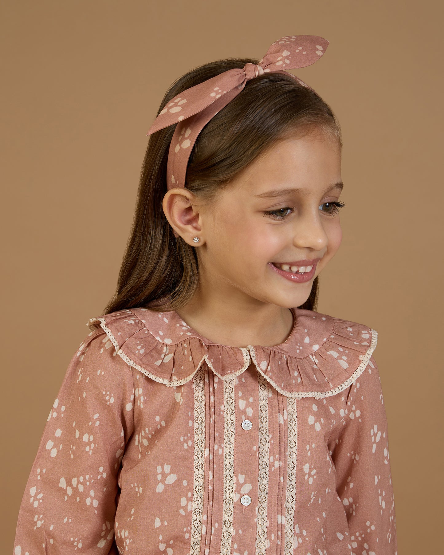 Early Sunday, Ella Blouse in Fawn Soft Pinkish Brown, made from Printed Cotton Cambric fabric, featuring relaxed fit, frill detailing on the collar, and lace inserts, shown in a close-up side view of a model wearing it