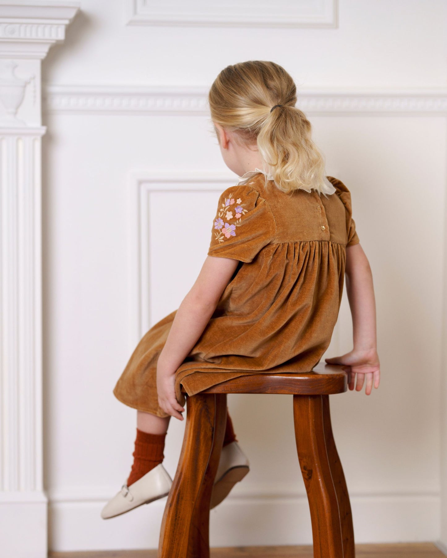 Early Sunday, Erika Dress in Almond, made from Dyed Cotton Velvet fabric, featuring Flowy A-line silhouette allows ease of movement and day-long comfort, shown in a back view of model wearing it