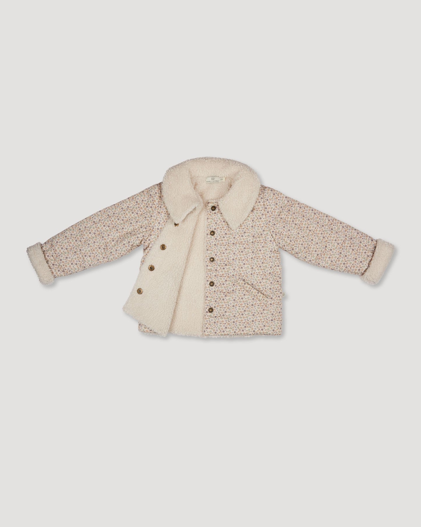 Early Sunday, Franka Jacket in Miny Flowers print, made from Printed 30s Cotton Twill fabric, featuring Cozy, softly structured jacket with a plush sherpa lining and gentle detailing for warmth without bulk, shown in a closeup flat-lay view