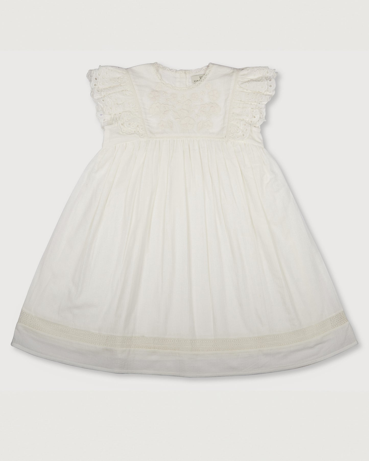 Early Sunday, Georgia Dress in Ivory print, made from Cotton Tiny Swiss Dots fabric, featuring Flutter sleeves, pintuck detailing, and a flowy, gathered silhouette, shown in a front flat-lay view
